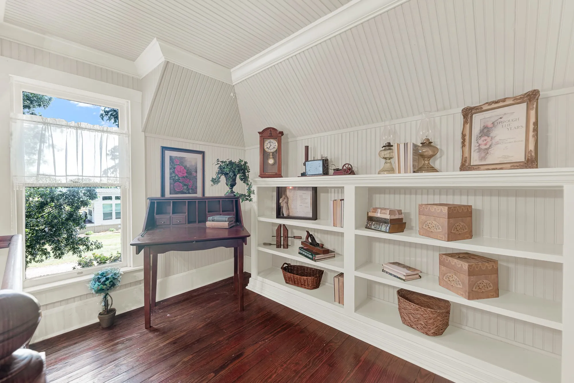 Custom built-in bookshelves, beadboard walls, and abundant natural light create a cozy library that feels both timeless and inviting. Spend a quiet afternoon surrounded by favorite books, or enjoy a peaceful workspace tucked away from the rest of the home.
