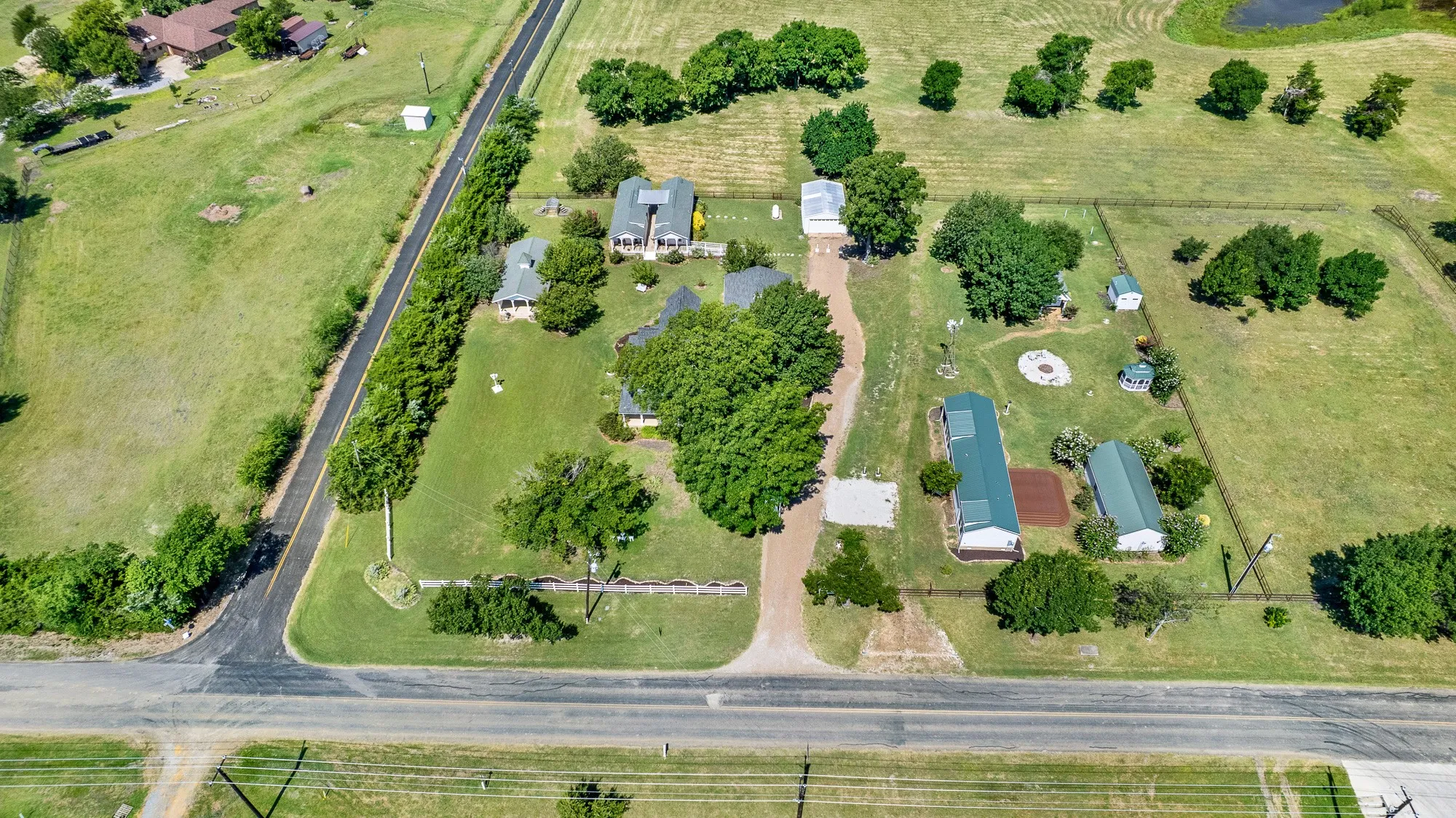 Perfectly positioned on a spacious corner lot, this unique estate enjoys an impressive presence with mature trees, white fencing, and beautifully maintained grounds. Surrounded by newer luxury homes on acreage, the property offers the charm of country living while blending seamlessly into one of the area's most desirable rural neighborhoods.