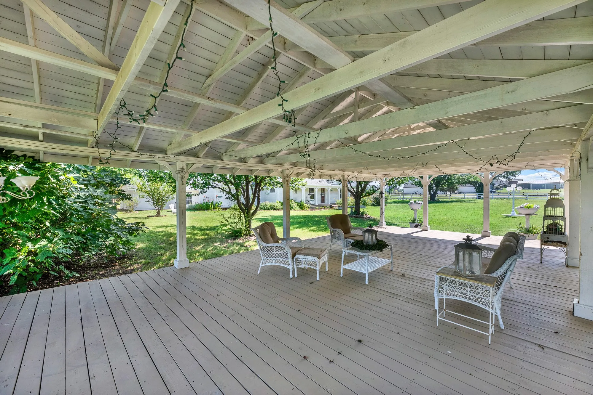 Inside, the pavilion offers abundant room for seating, dining, and entertaining, creating a natural extension of the outdoor living space. Whether hosting guests or enjoying a quiet afternoon in the shade, this versatile structure provides a comfortable setting with picturesque views across the shared lawn and surrounding property.