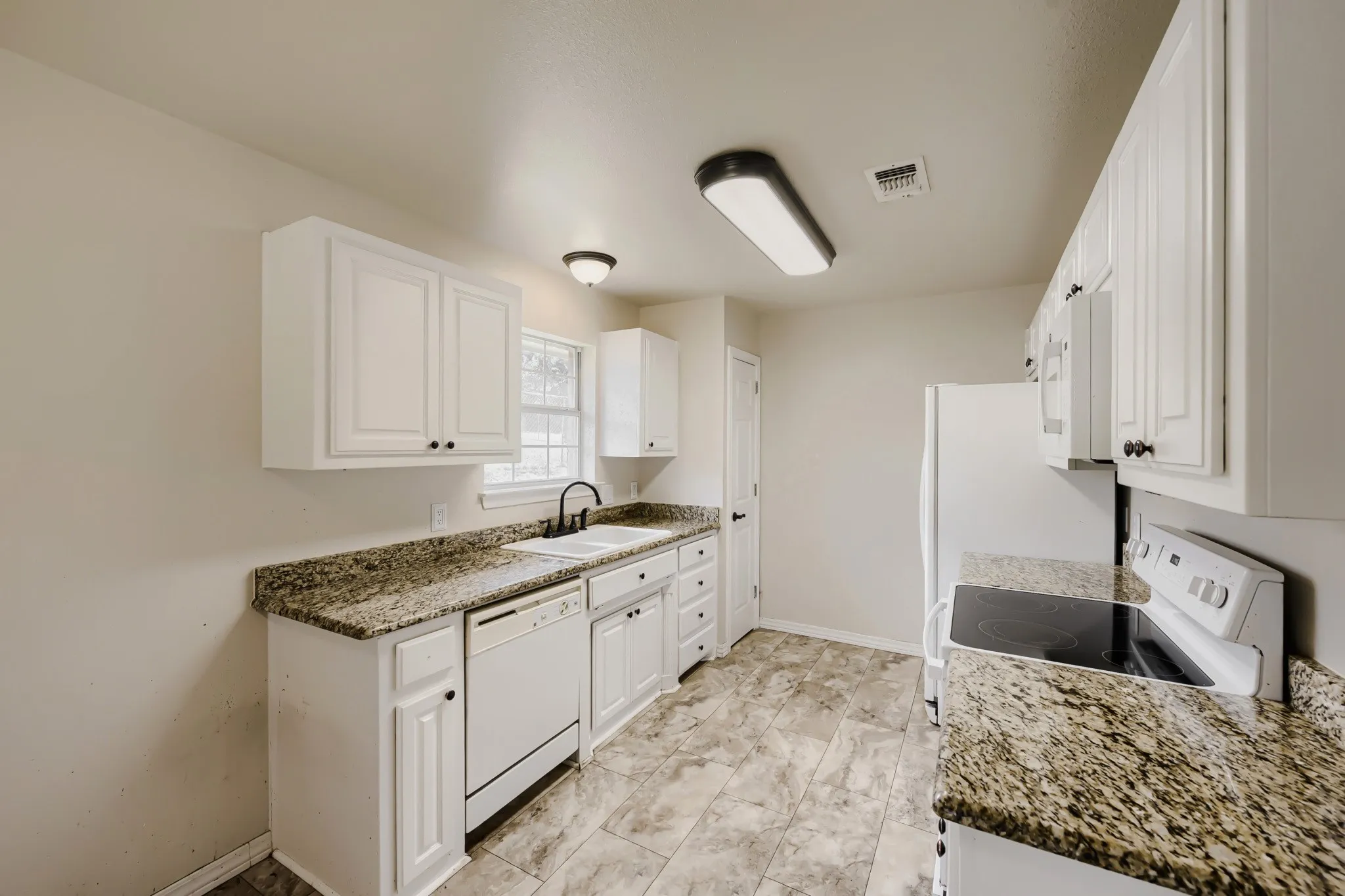 Kitchen featuring white cabinetry, granite-patterned countertops, tile flooring, a white electric range, and a white dishwasher