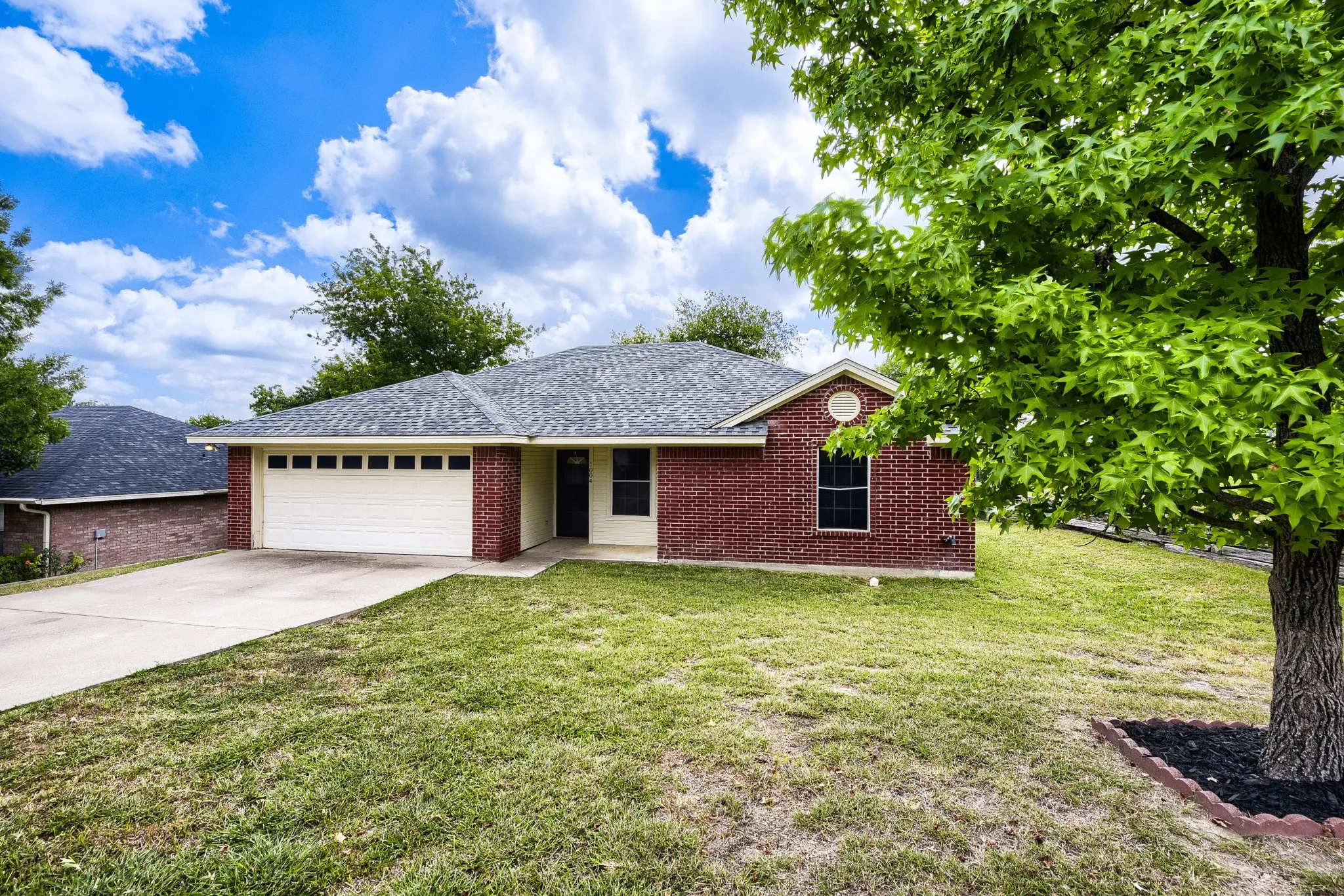 Brick and siding exterior with a shingled roof