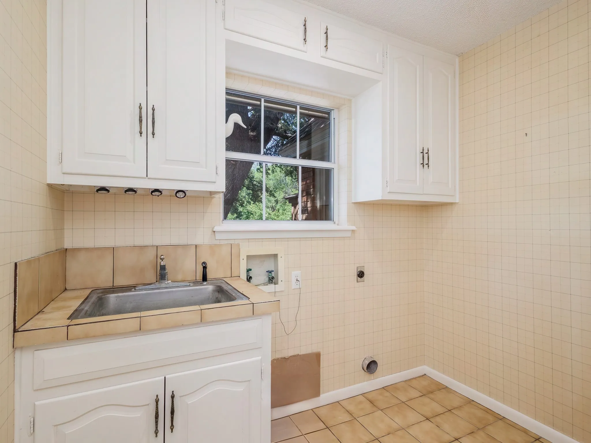 Enjoy the beautiful backyard and pond while doing the laundry.