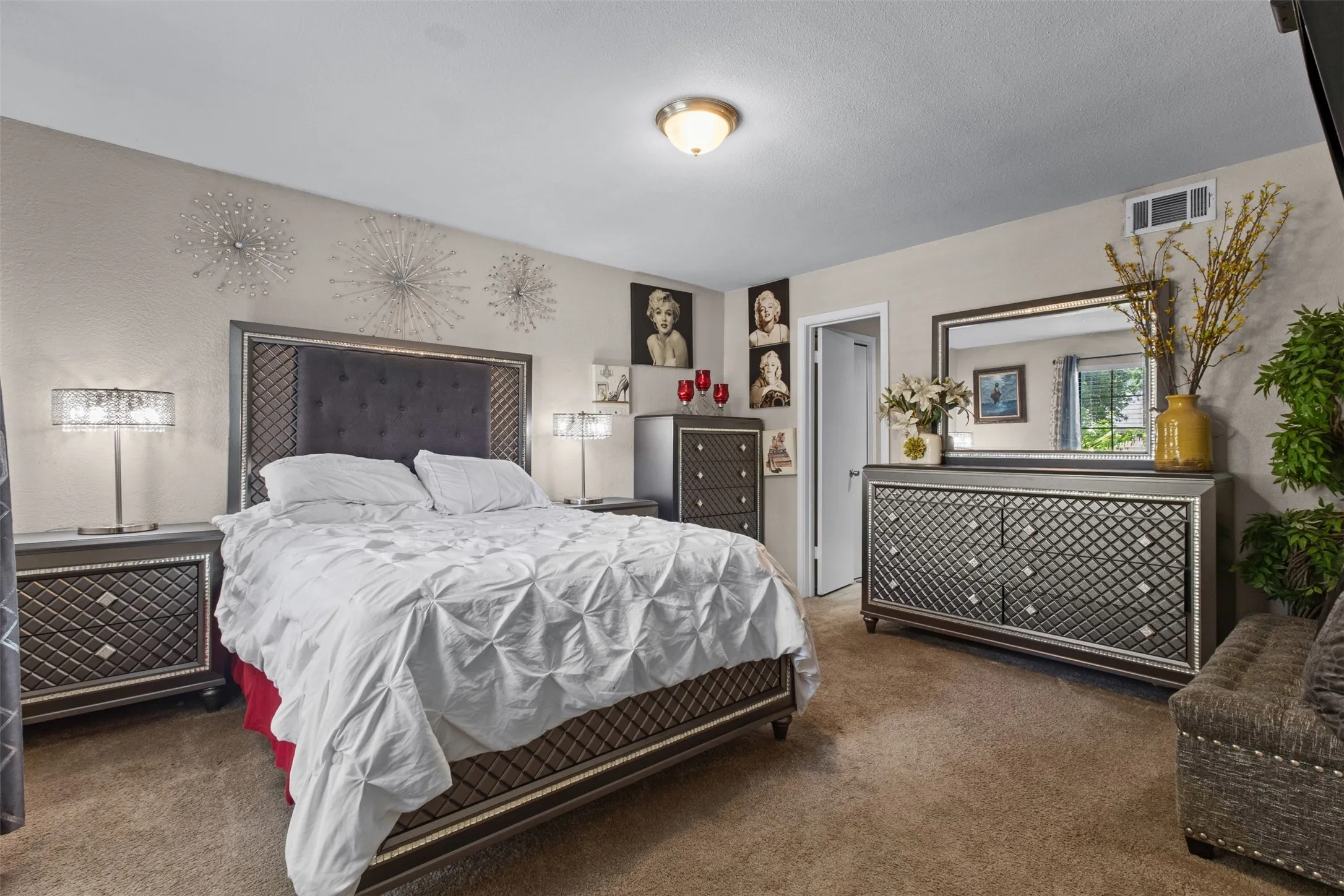Carpeted bedroom featuring a neutral wall color and built-in ceiling light