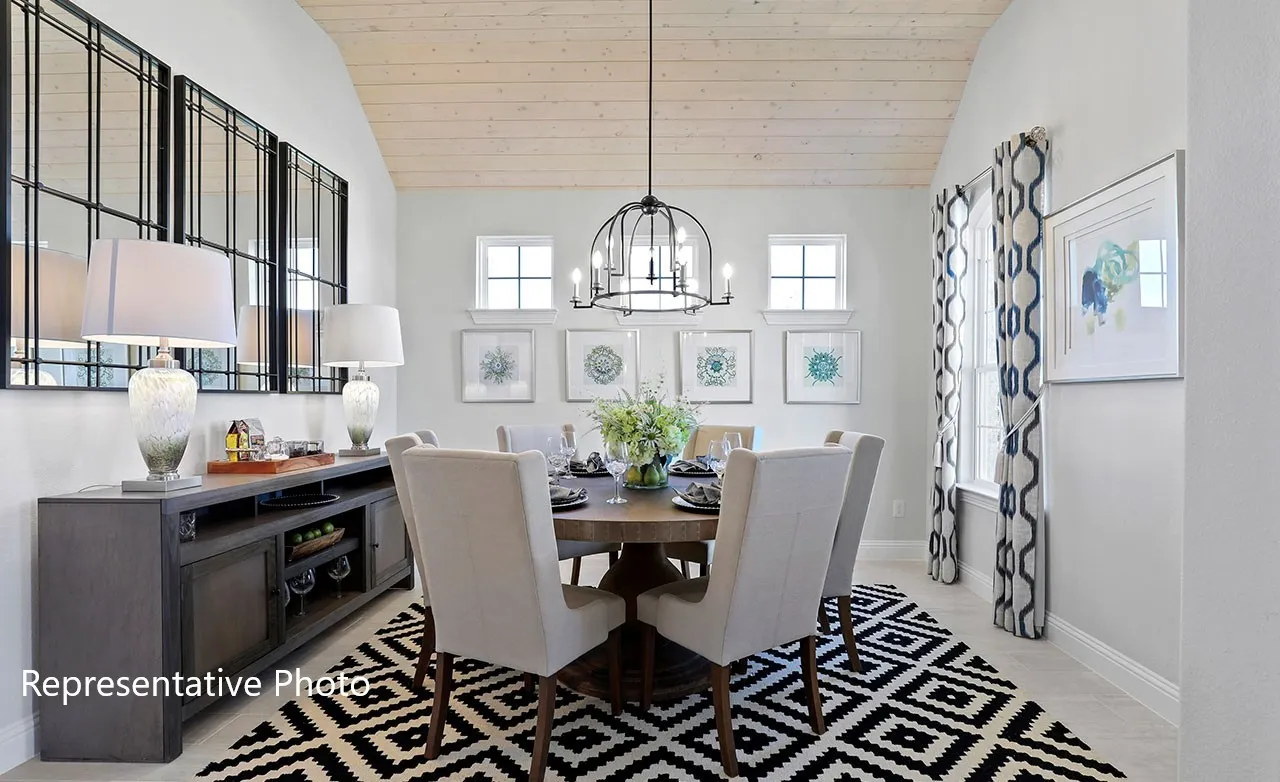 Vaulted wood-finish ceiling above a dining area featuring a dark wood-finish round table and upholstered chairs