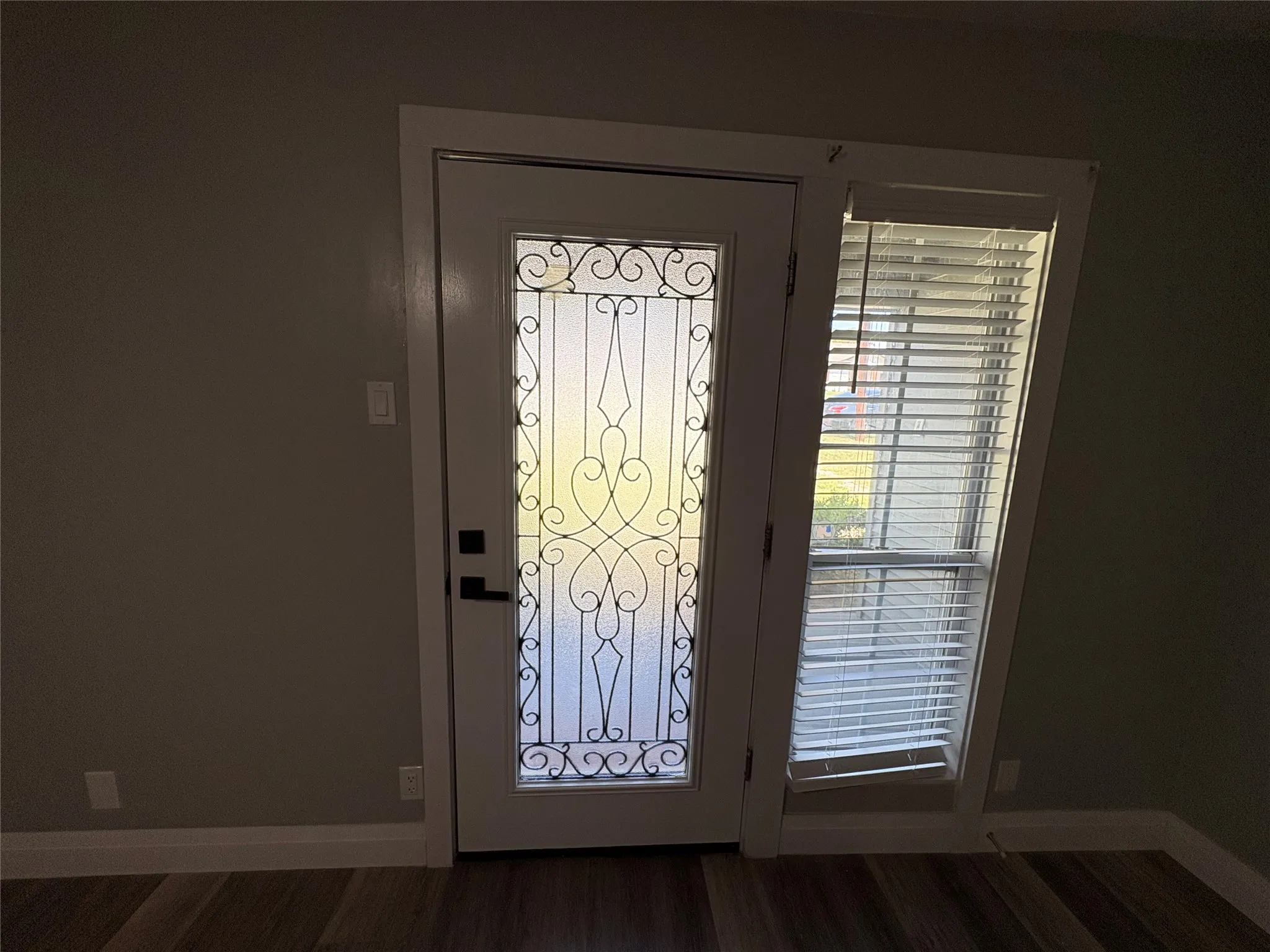 new decorative iron accent front door at covered front porch