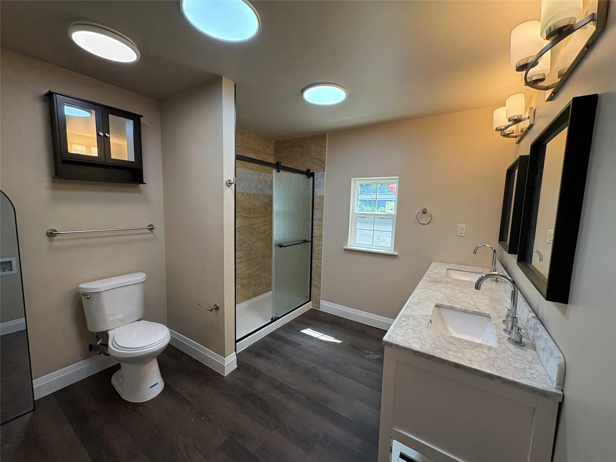 remodeled master bath with medicine cabinet, shower for 2, dual sink vanity with mirrors & lights, spacious shower, & linen closet