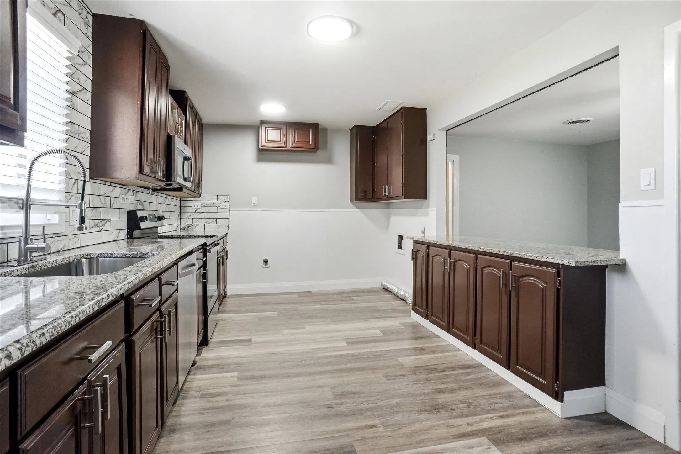  stainless farm sink, subway backsplash,  fridge can be placed at end of kitchen or in corner opposite the cooking area and upper cabinets removed