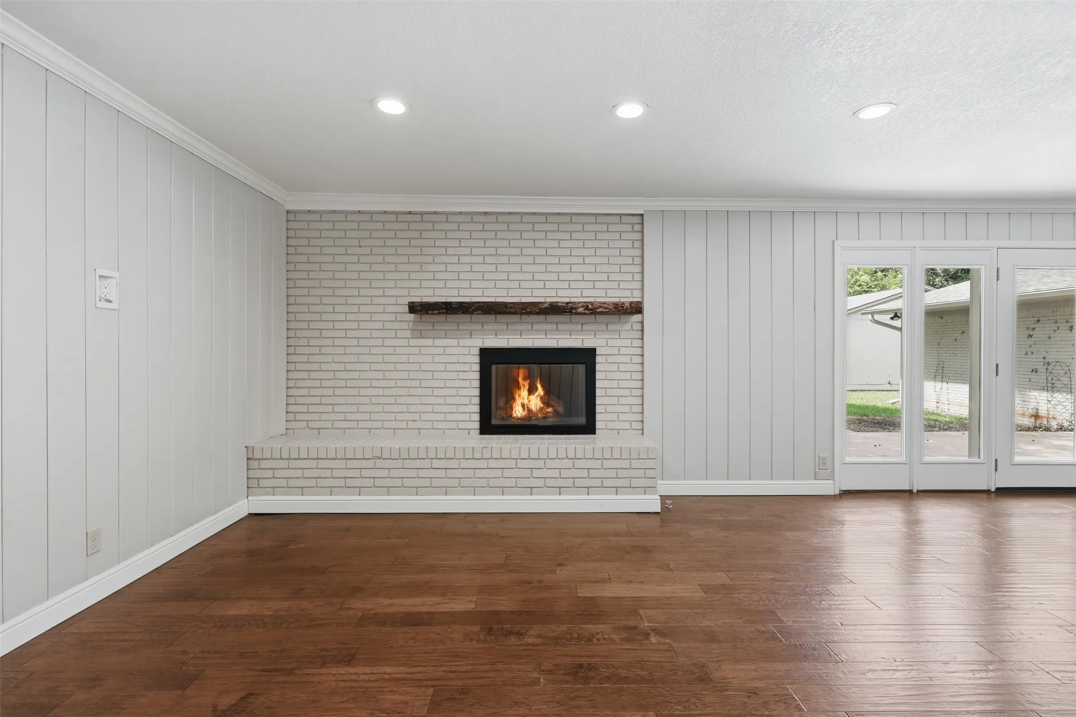 Brick fireplace with a distressed wood mantel and a raised hearth