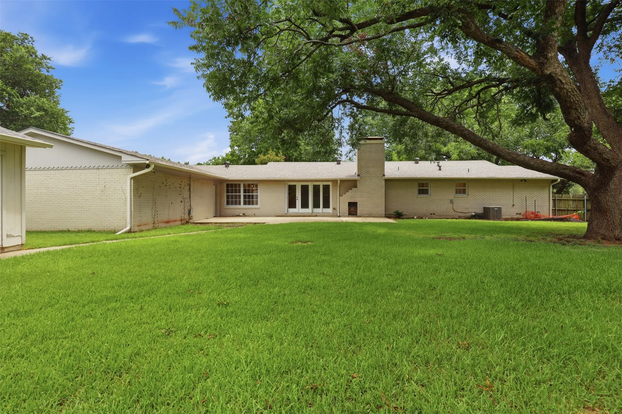 Expansive green lawn with mature trees