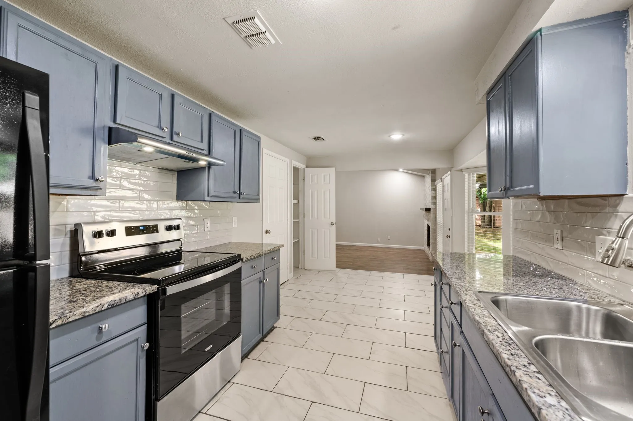 Black/Stainless Whirlpool Range with recirculating Vent hood; Black Refrigerator CONVEYS! (stays)