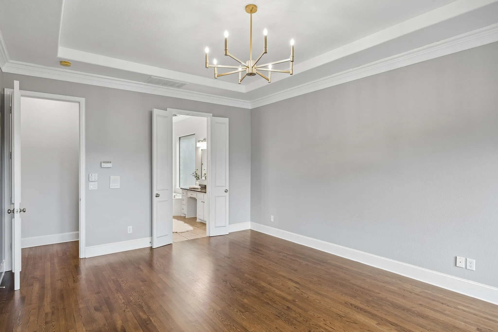 Primary suite has panoramic pool views and access via French doors.