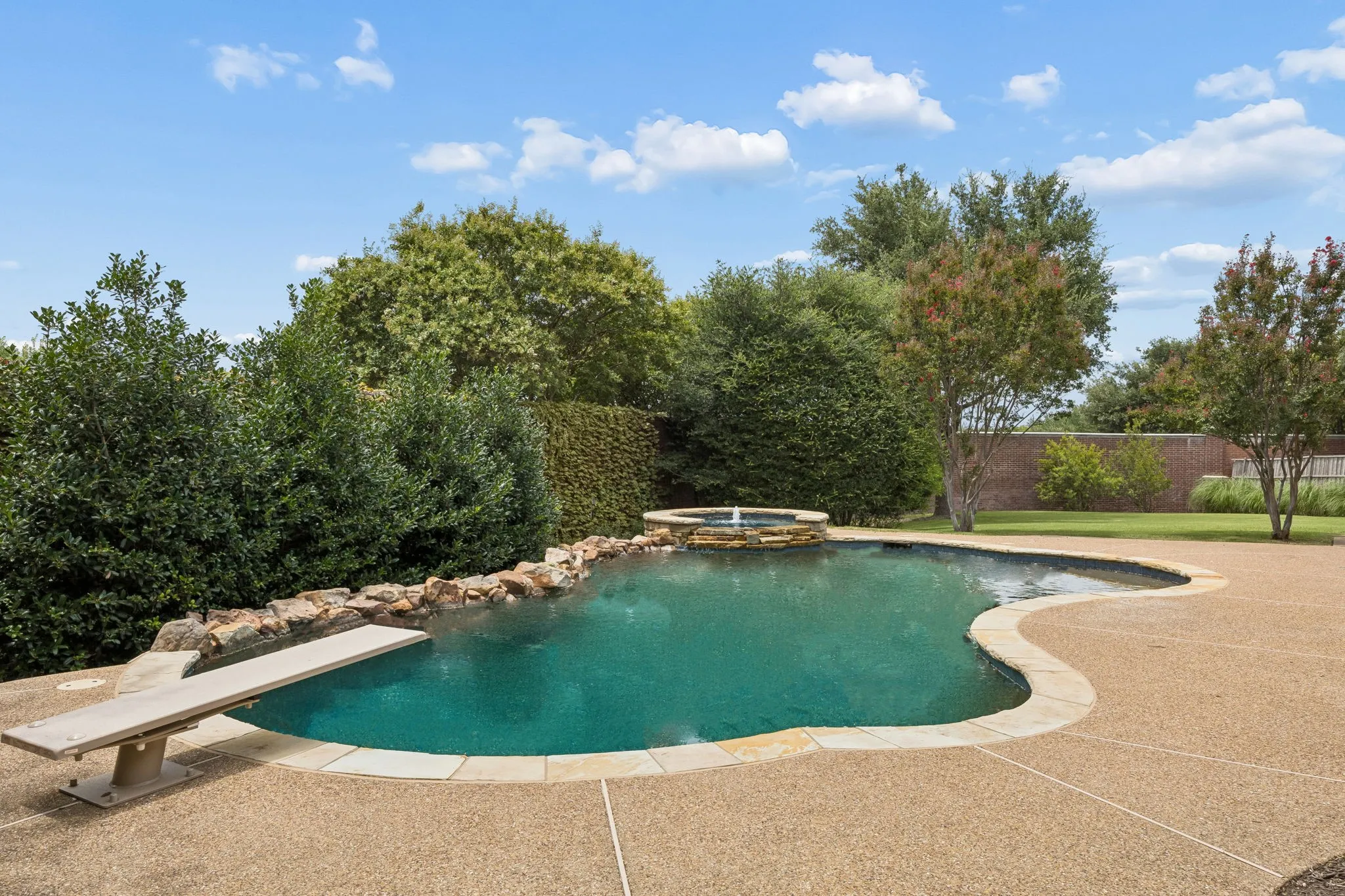 Expansive view of the pool and grassy area