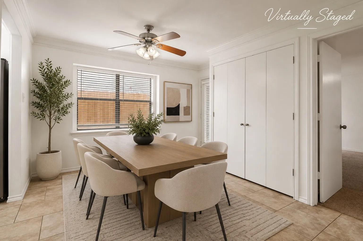 Dining area featuring tile flooring, a ceiling fan with light fixture, a window with blinds, and built-in bifold doors
