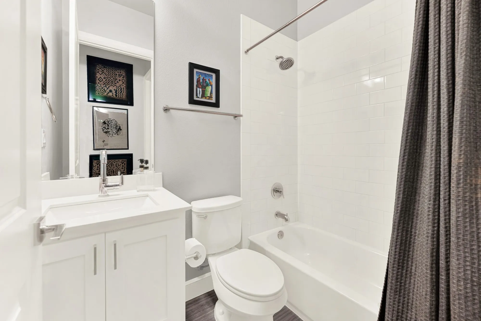 Bathroom featuring a single vanity with white cabinetry and a rectangular undermount sink
