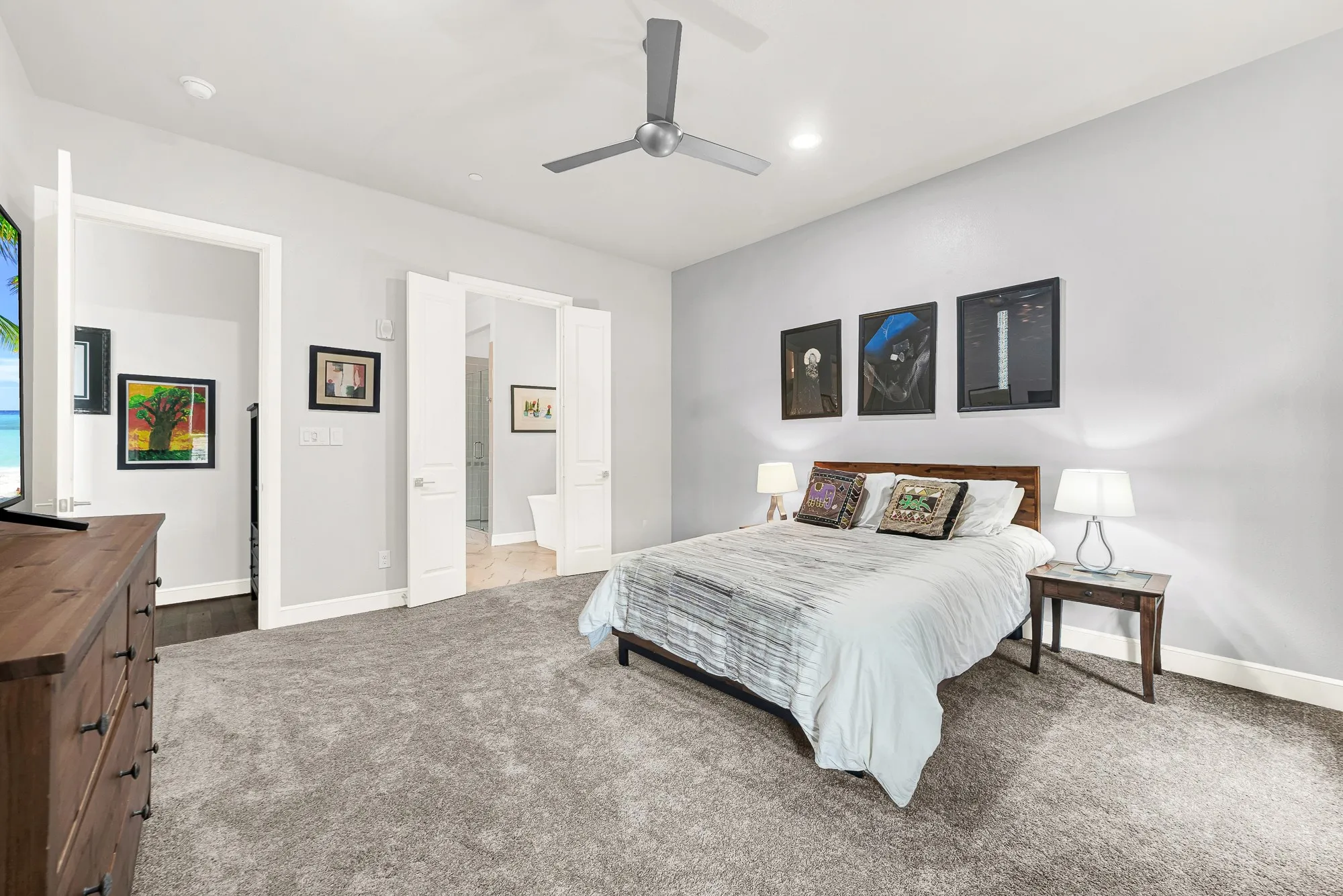 Plush carpeted room featuring a ceiling fan with integrated lighting, recessed lighting, and a doorway opening to a bathroom with wood-finish flooring