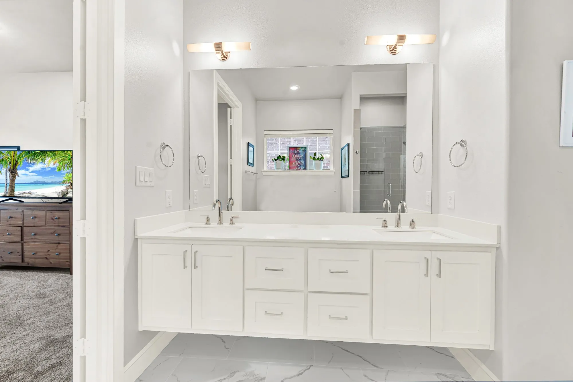 Dual vanity with white cabinetry and integrated sinks, quartz countertop, and large wall-mounted mirrors