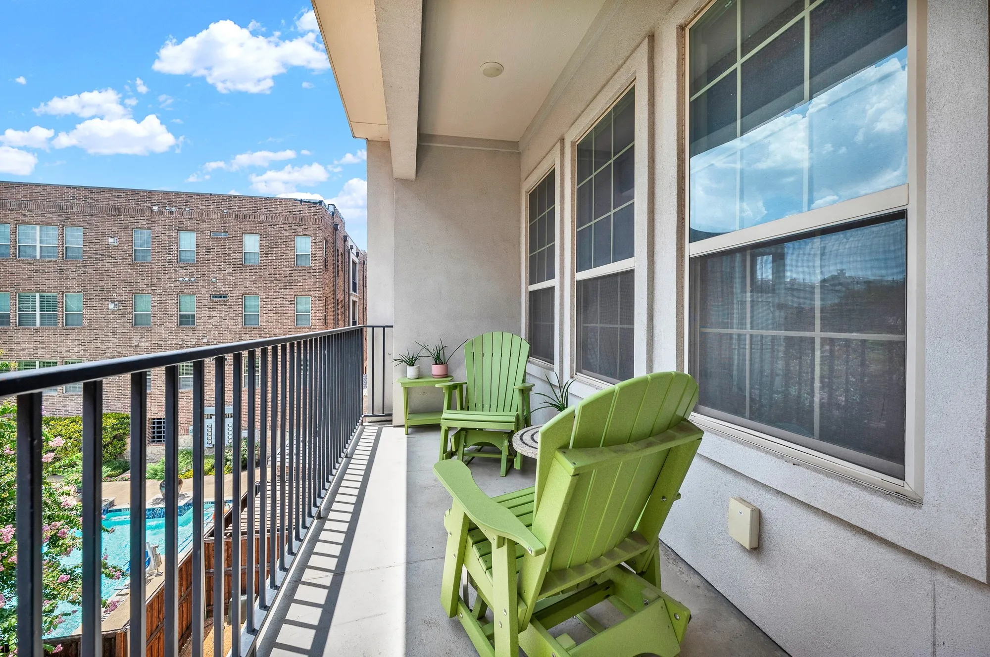 Private balcony with durable concrete flooring and black iron railings