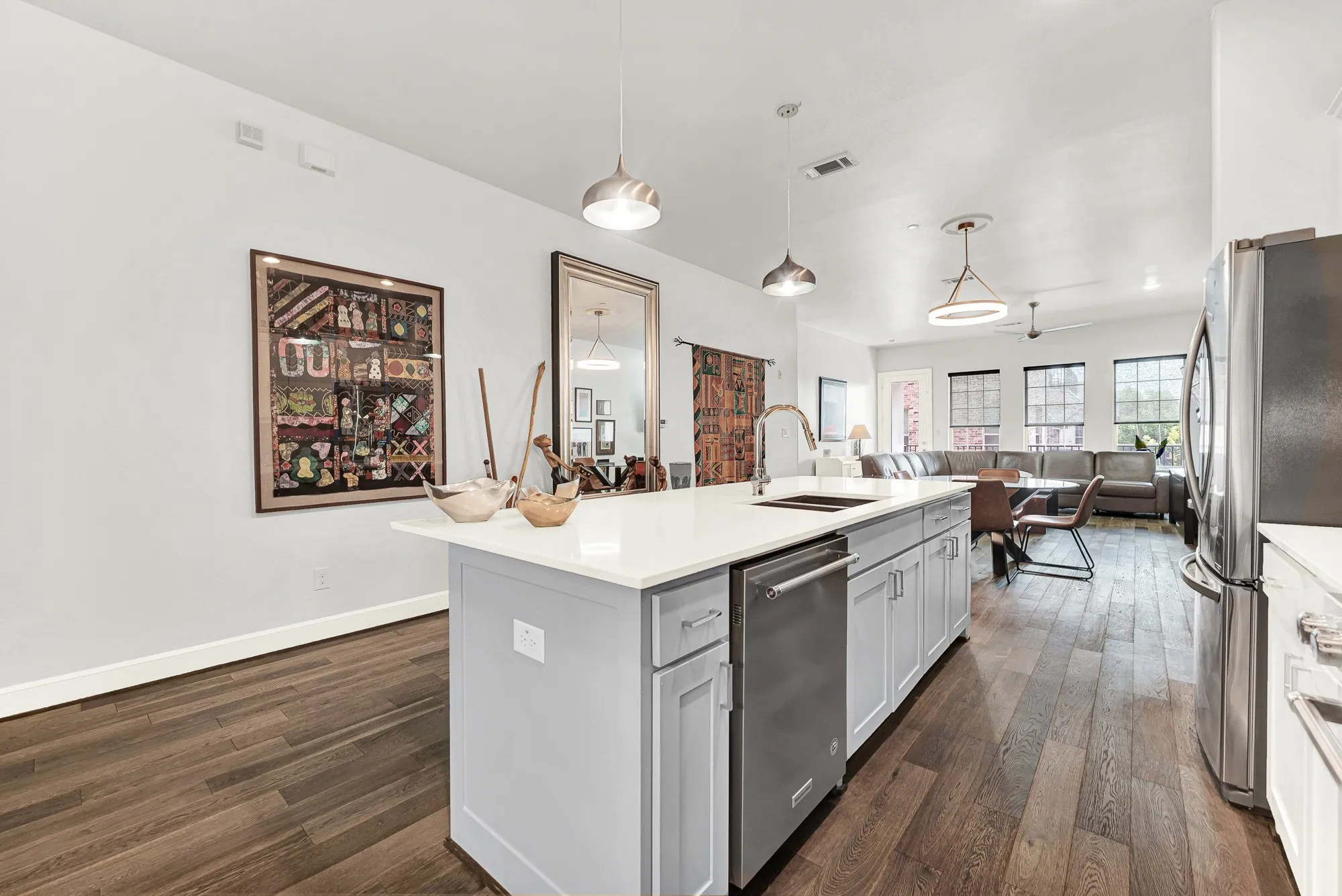 Large kitchen island with an undermount sink and stainless steel dishwasher