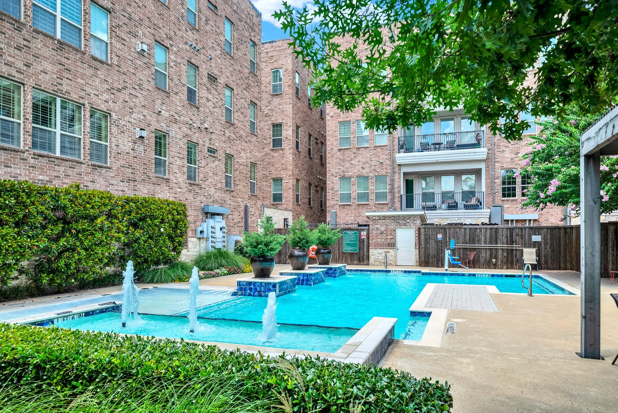 Resort-style pool area featuring water fountains and integrated tile details