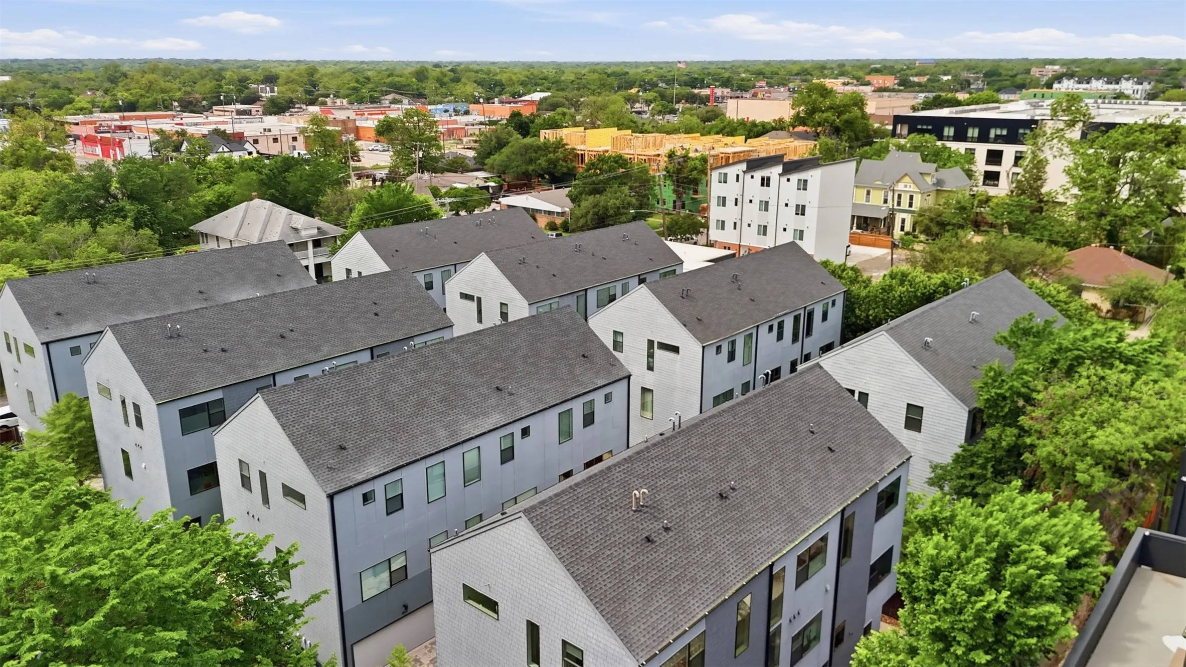 Aerial view of community surrounded by lush landscape and urban walkability.