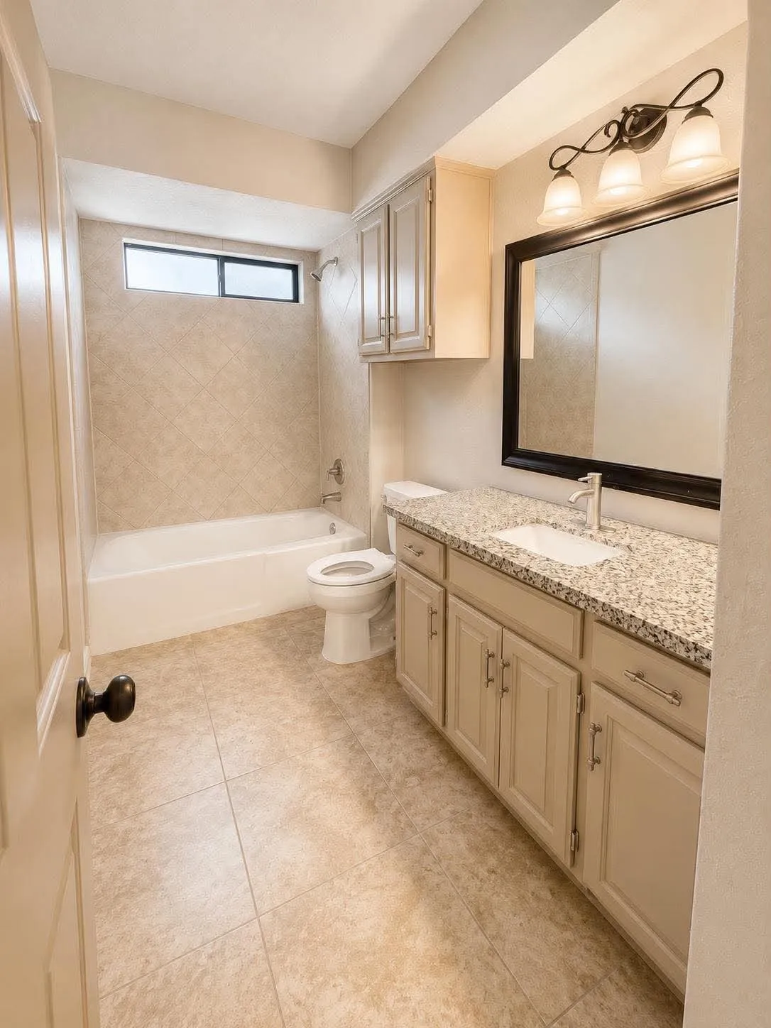 Full bathroom featuring a single vanity with stone countertop, undermount sink, and light-toned cabinetry