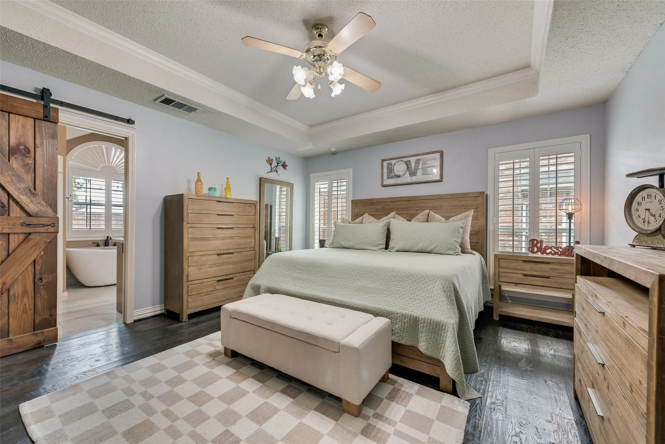 Updated primary bedroom with real hardwood flooring and barn door to ensuite!
