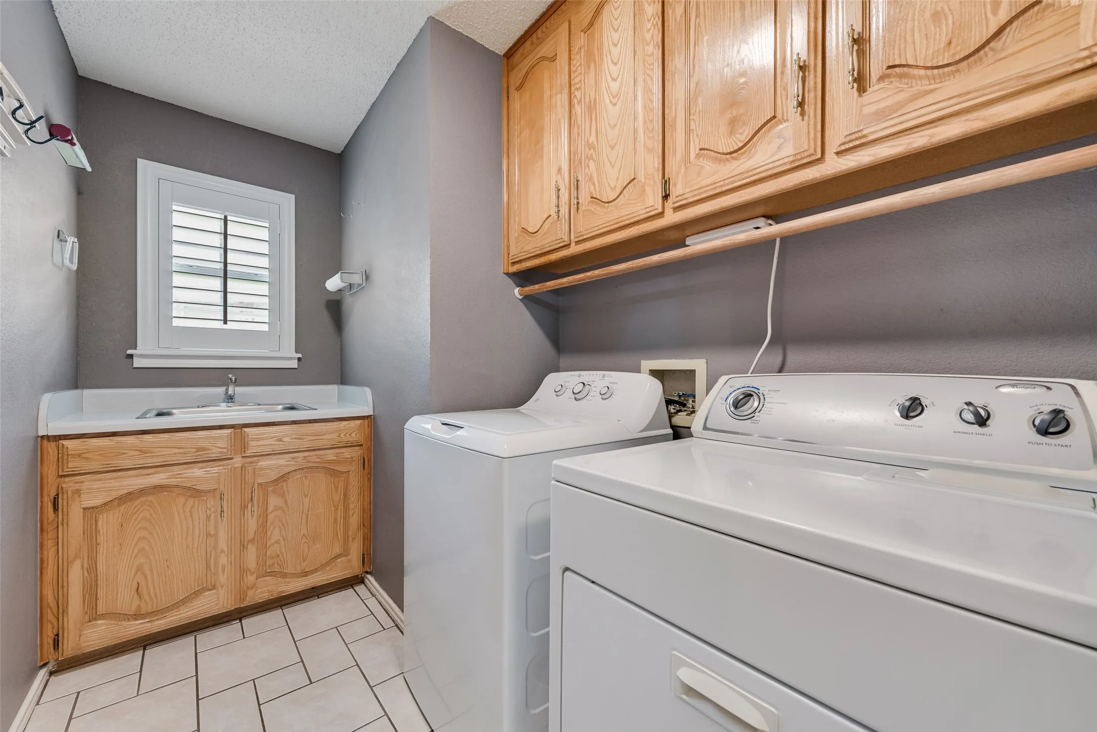Large laundry with built in cabinets and sink!