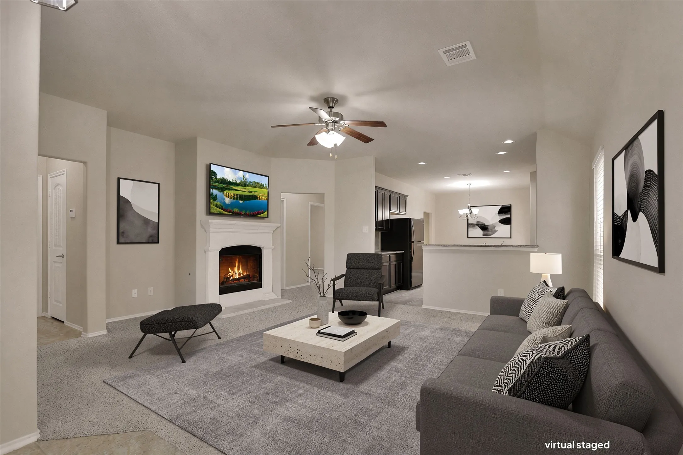 Living area with a fireplace featuring a detailed mantel, soft gray carpet, and a ceiling fan with integrated lighting