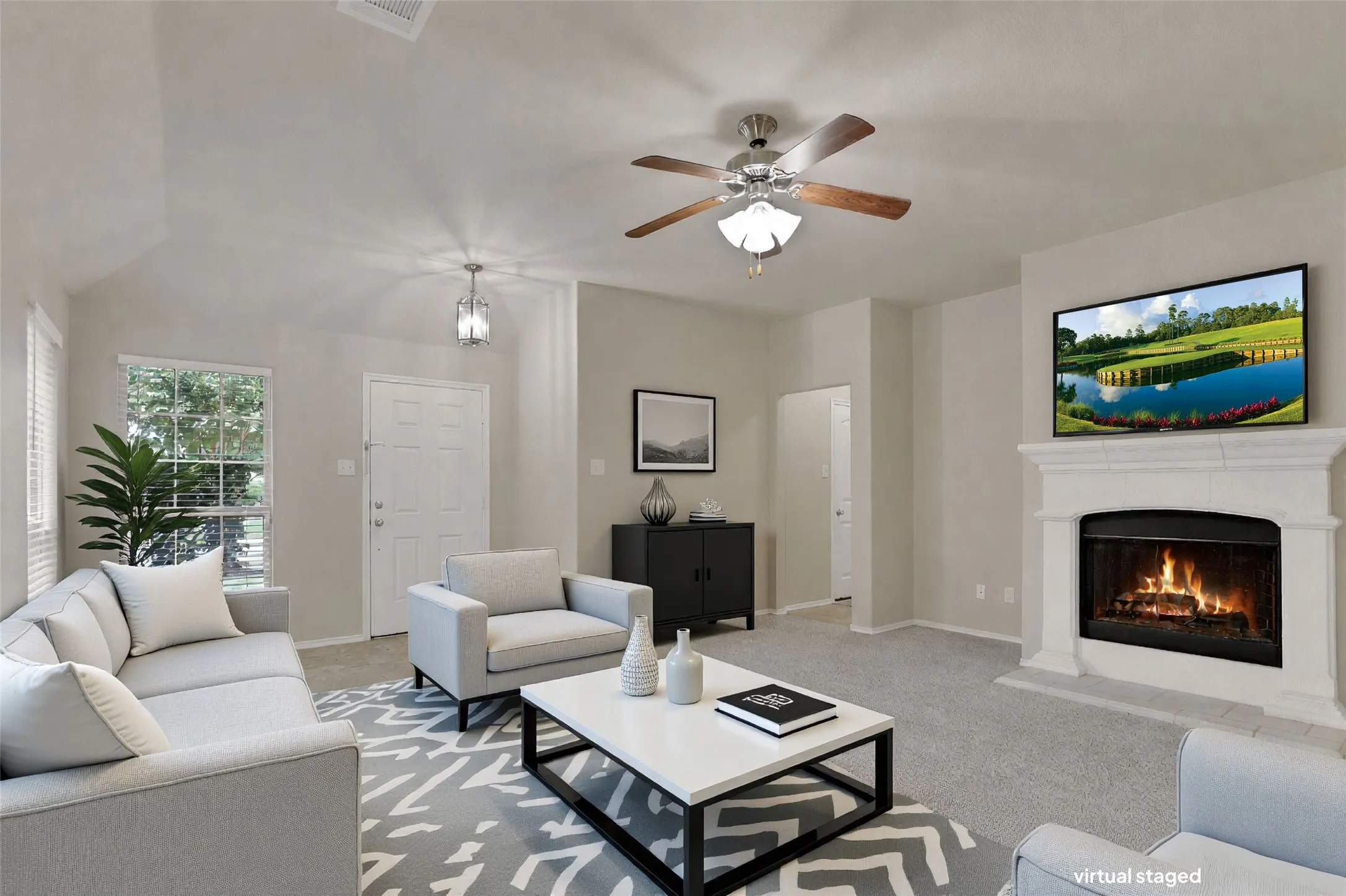 Inviting living space featuring a white painted fireplace with a mantel, a ceiling fan with integrated lighting, and neutral wall tones