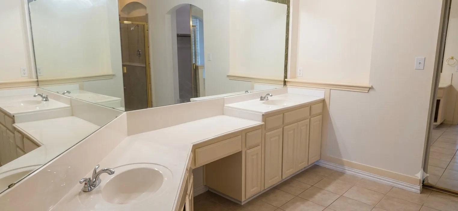 Double vanity featuring integral sinks, expansive countertop space, and lower cabinetry with storage