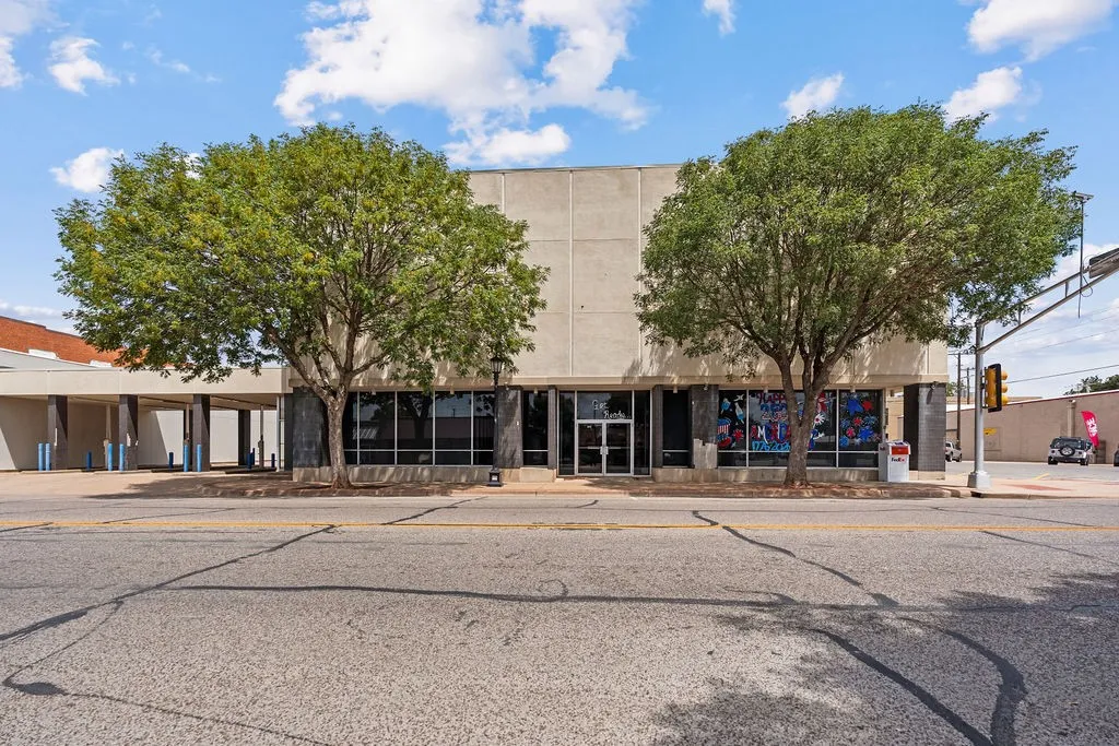 Two-story commercial building featuring a stone facade and expansive ground-level windows