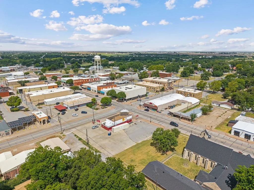 Aerial perspective showcasing a town with varied commercial structures and residential areas