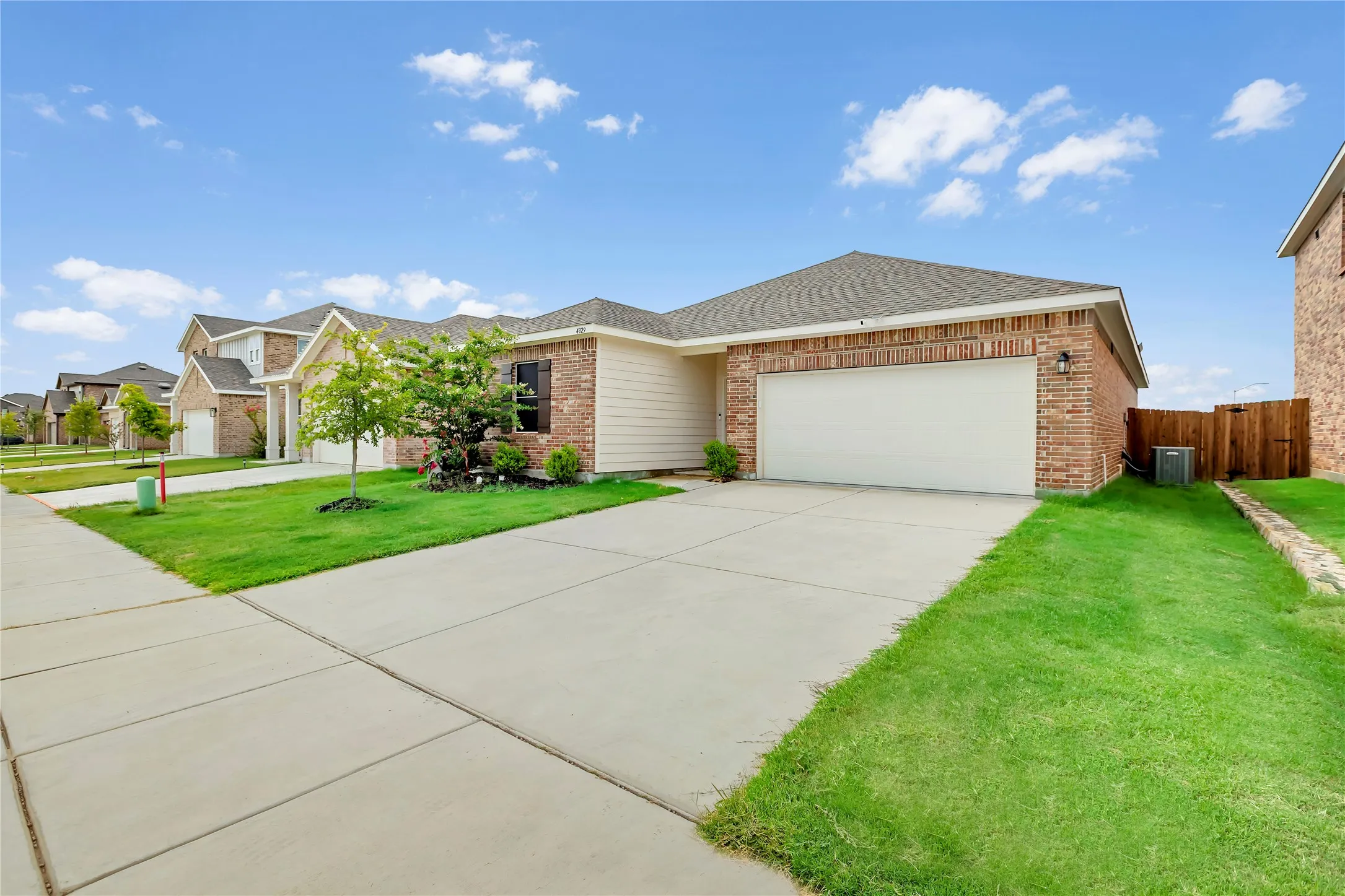 Brick and siding exterior with an attached garage