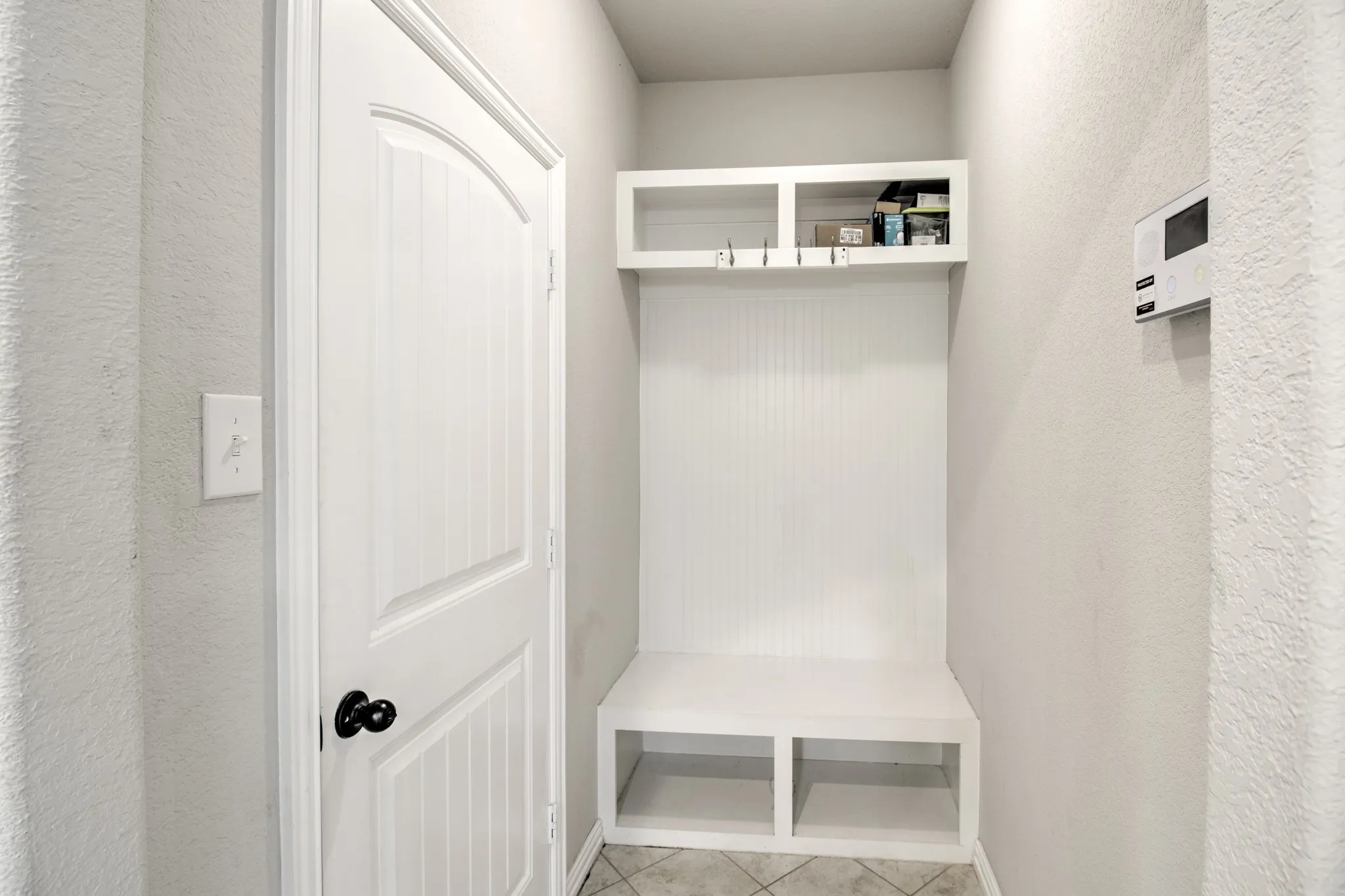 Built-in mudroom bench with cubby storage and coat hooks