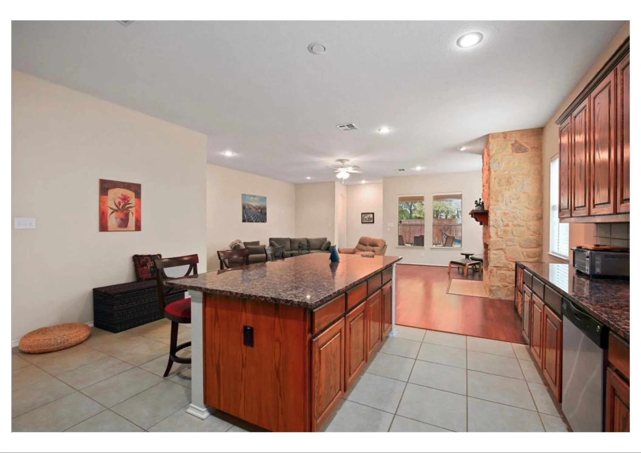 Kitchen island with a stone-finish countertop and wood-finish cabinetry