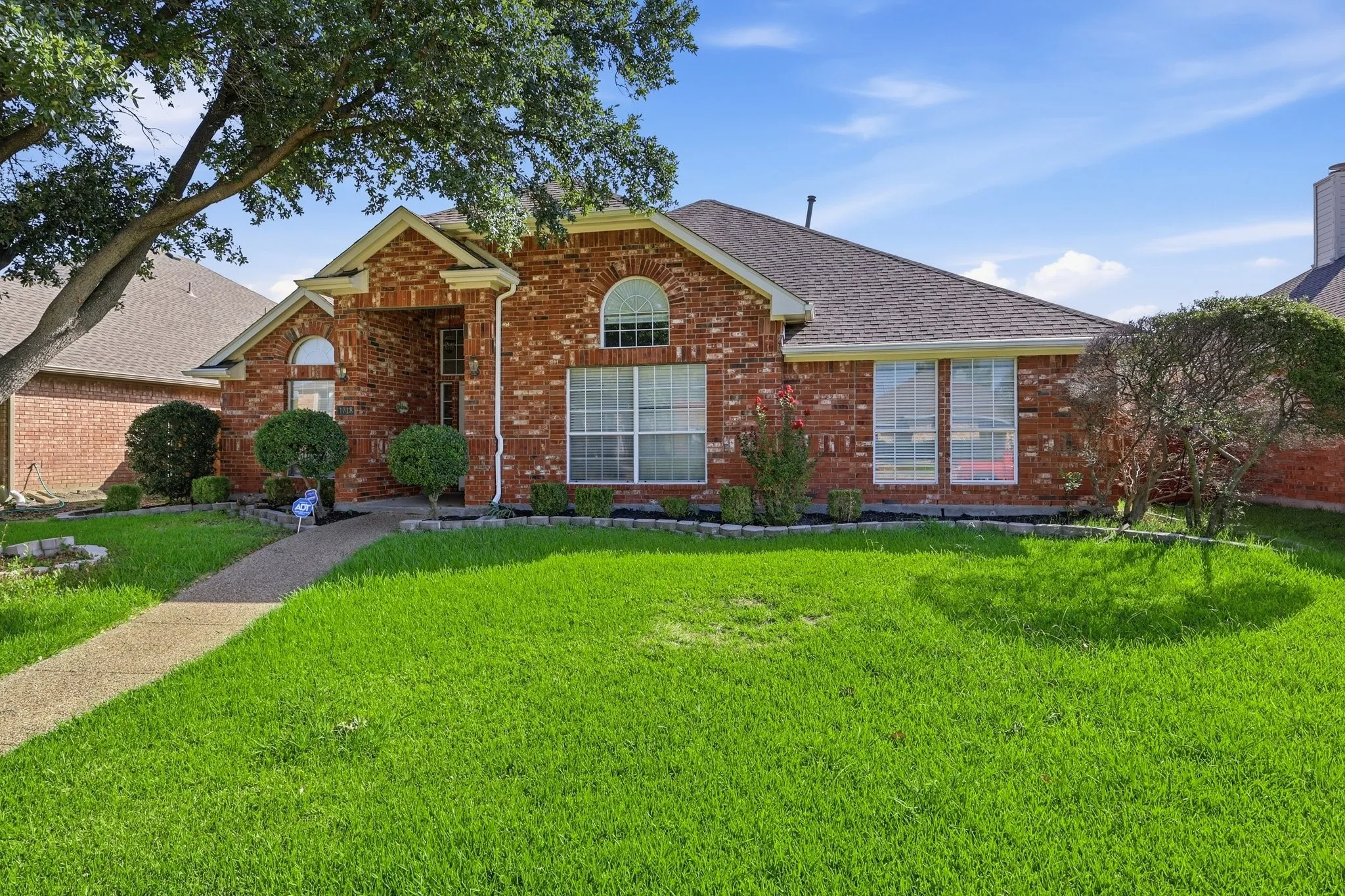 Brick exterior residence featuring a covered entry
