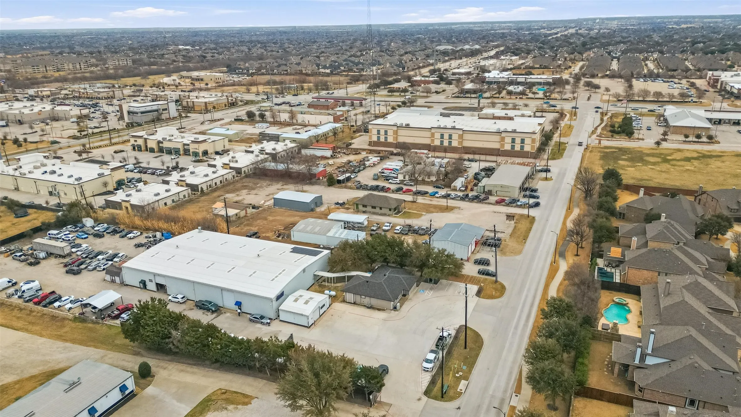 Aerial perspective showcasing a commercial building with an expansive parking area