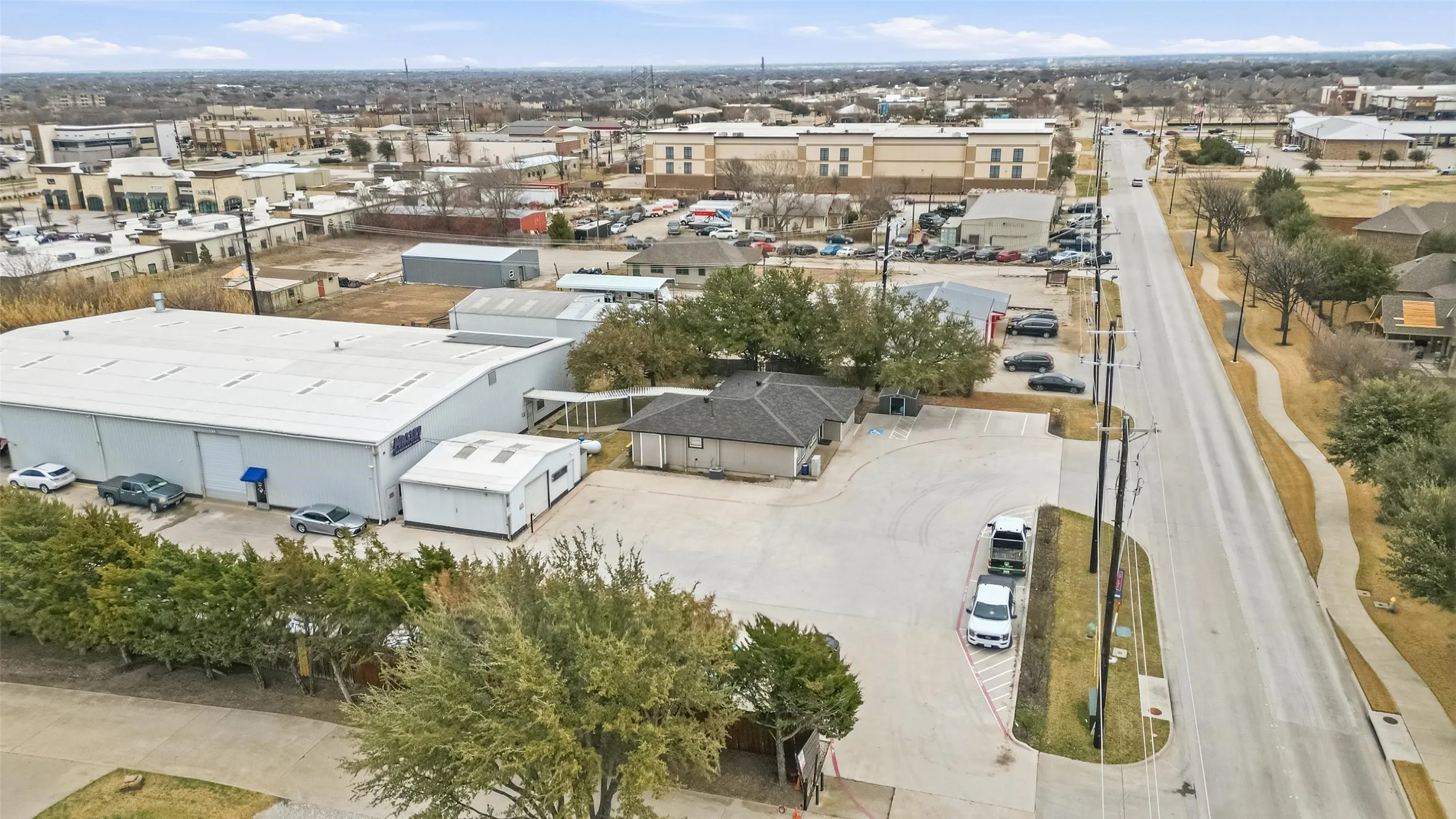 Aerial perspective showcasing a commercial property with multiple structures