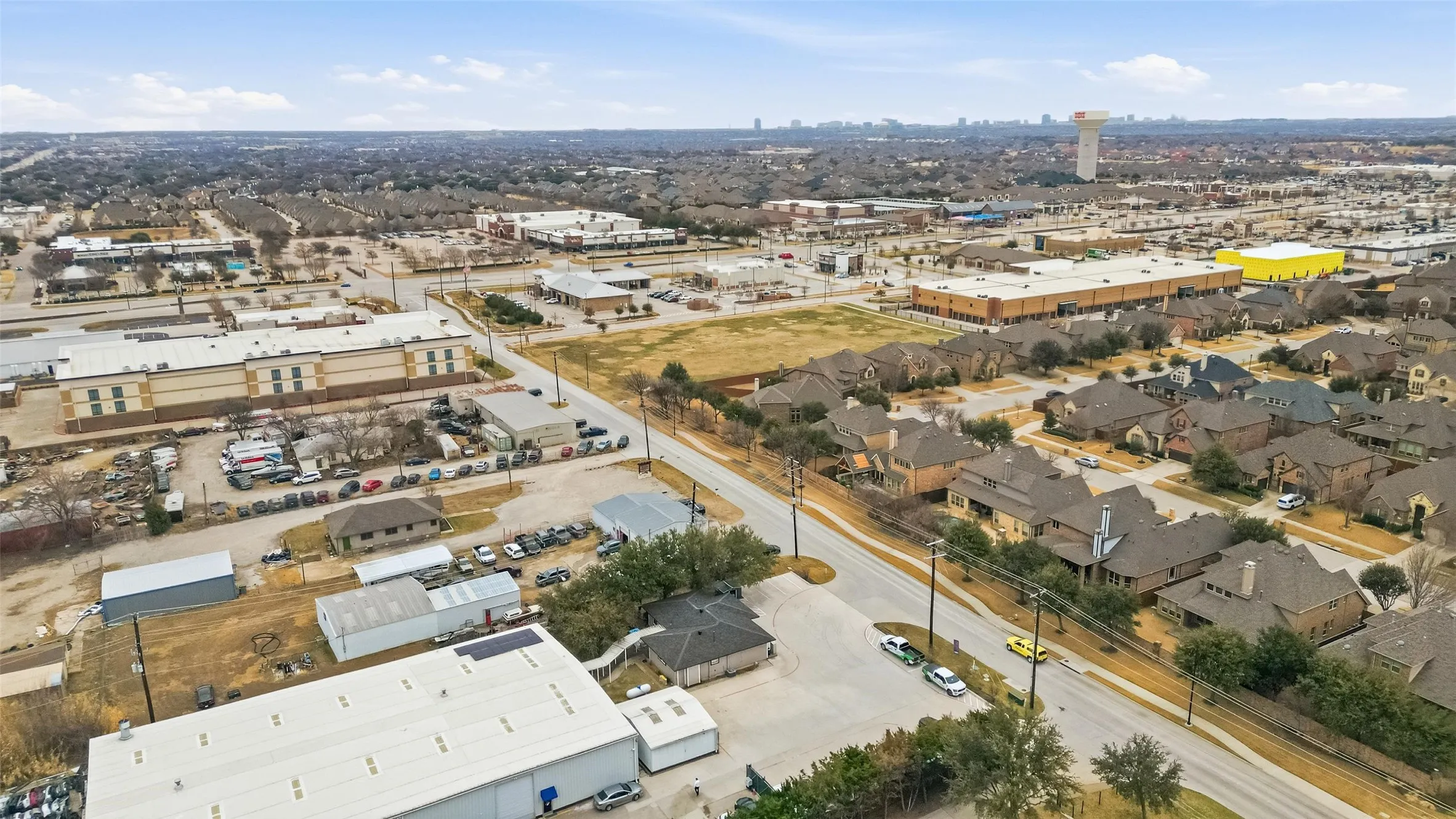 Aerial perspective showcasing a mixed-use area with residential properties and commercial buildings