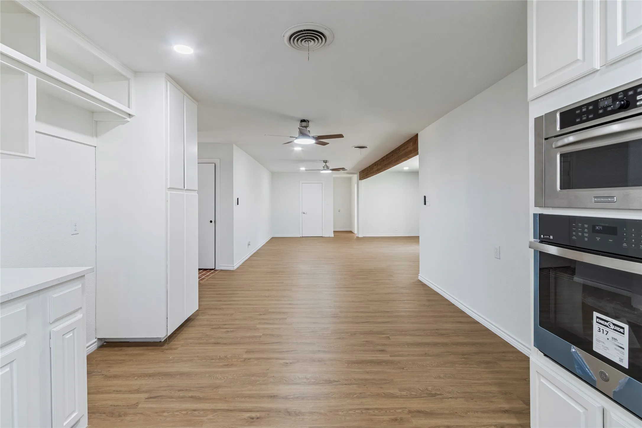 Light wood-finish flooring extending through the space
