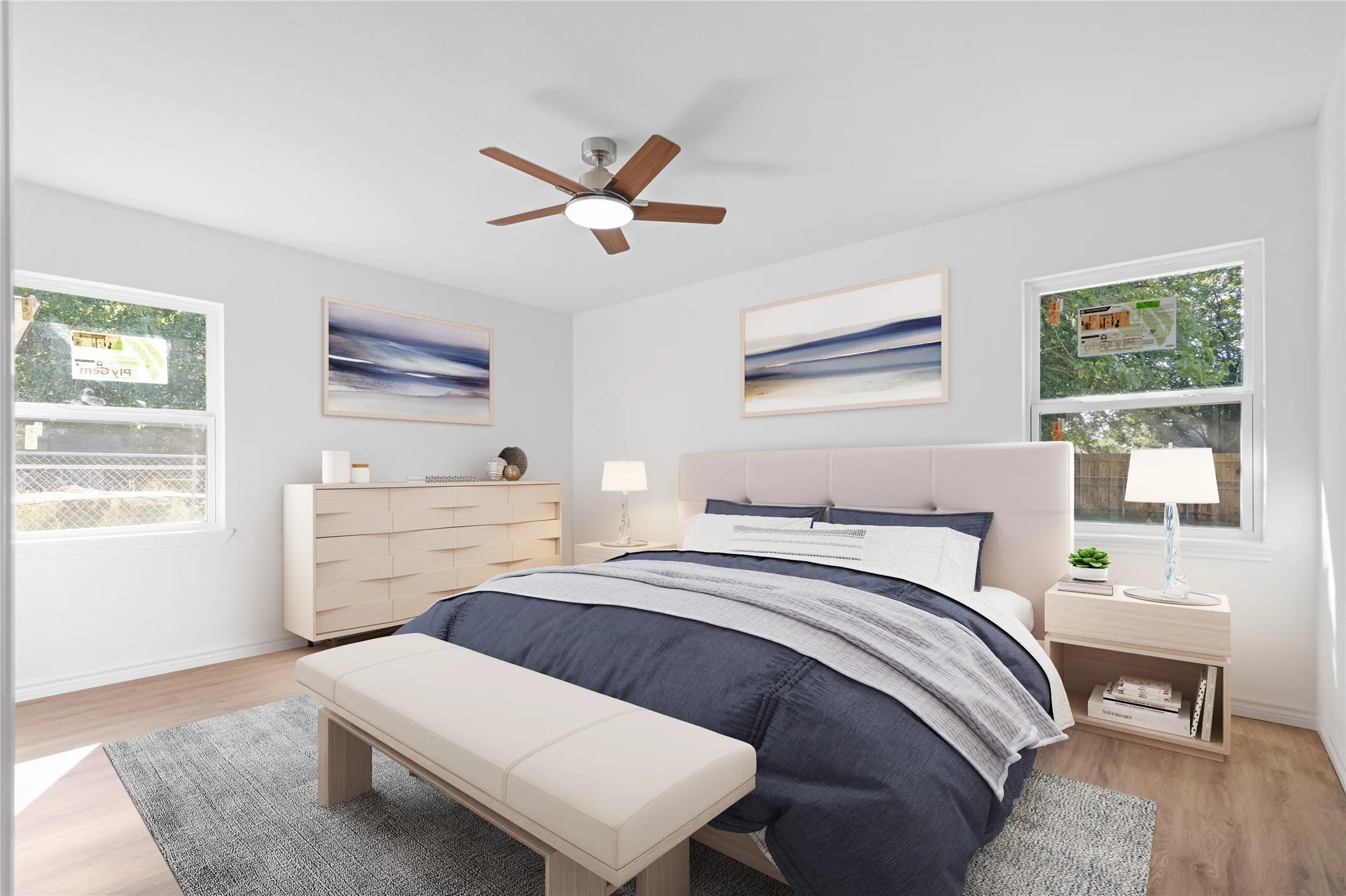 Bedroom featuring light wood-finish flooring and a ceiling fan with integrated lighting