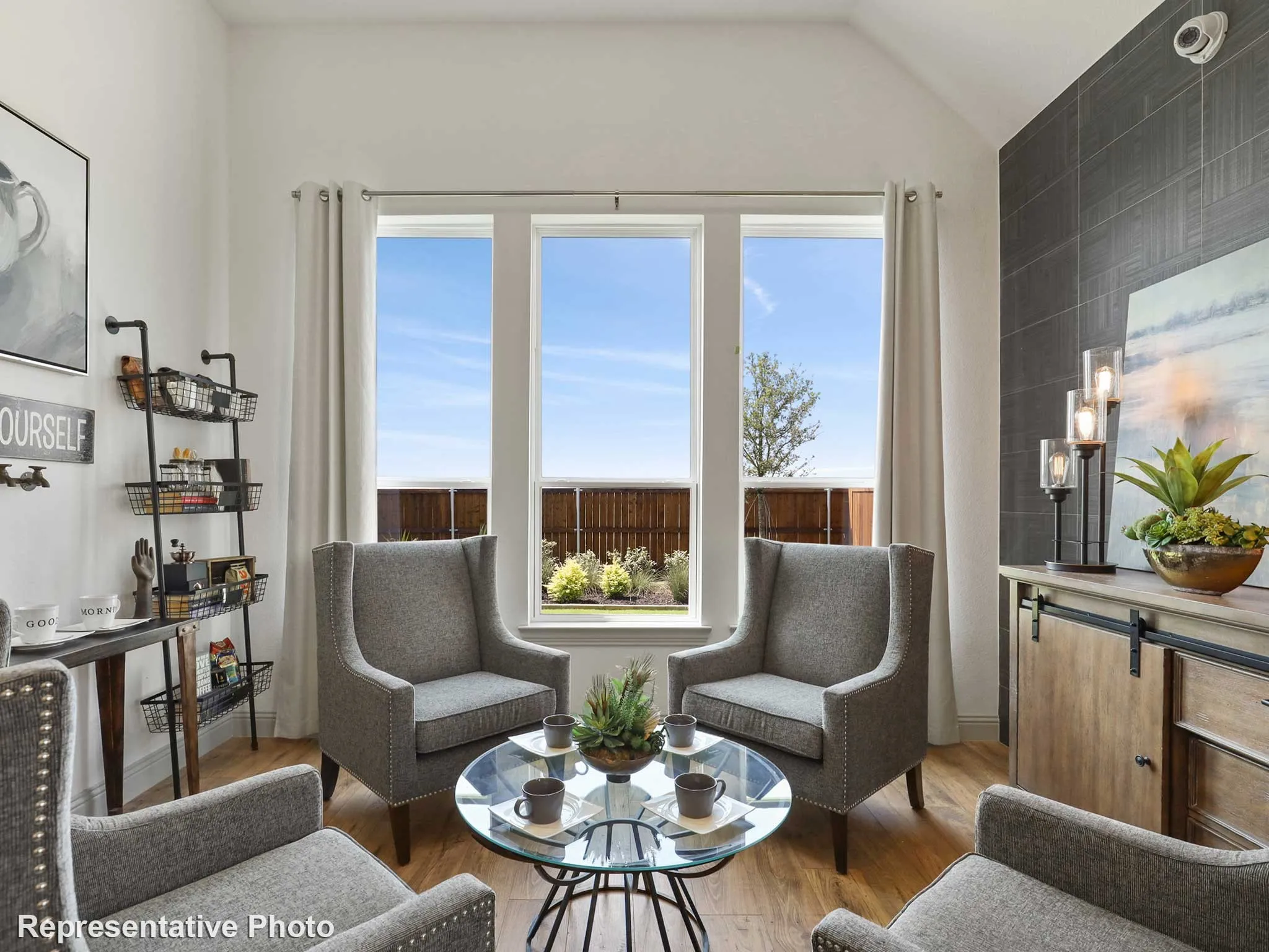 Bright interior space featuring a vaulted ceiling and ample natural light from multiple windows