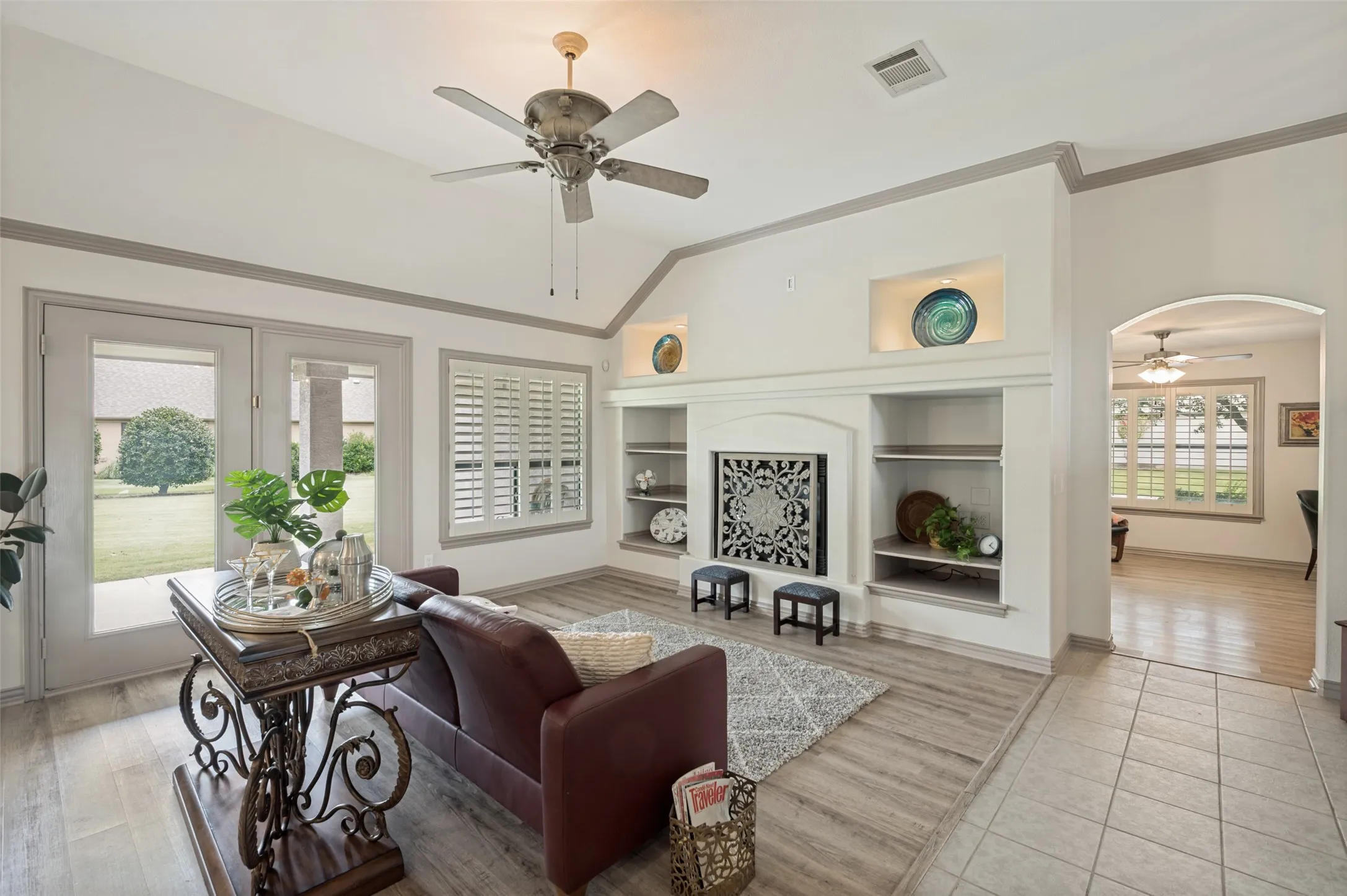 Great Room with plantation shutters, fireplace, and an outlet for the TV