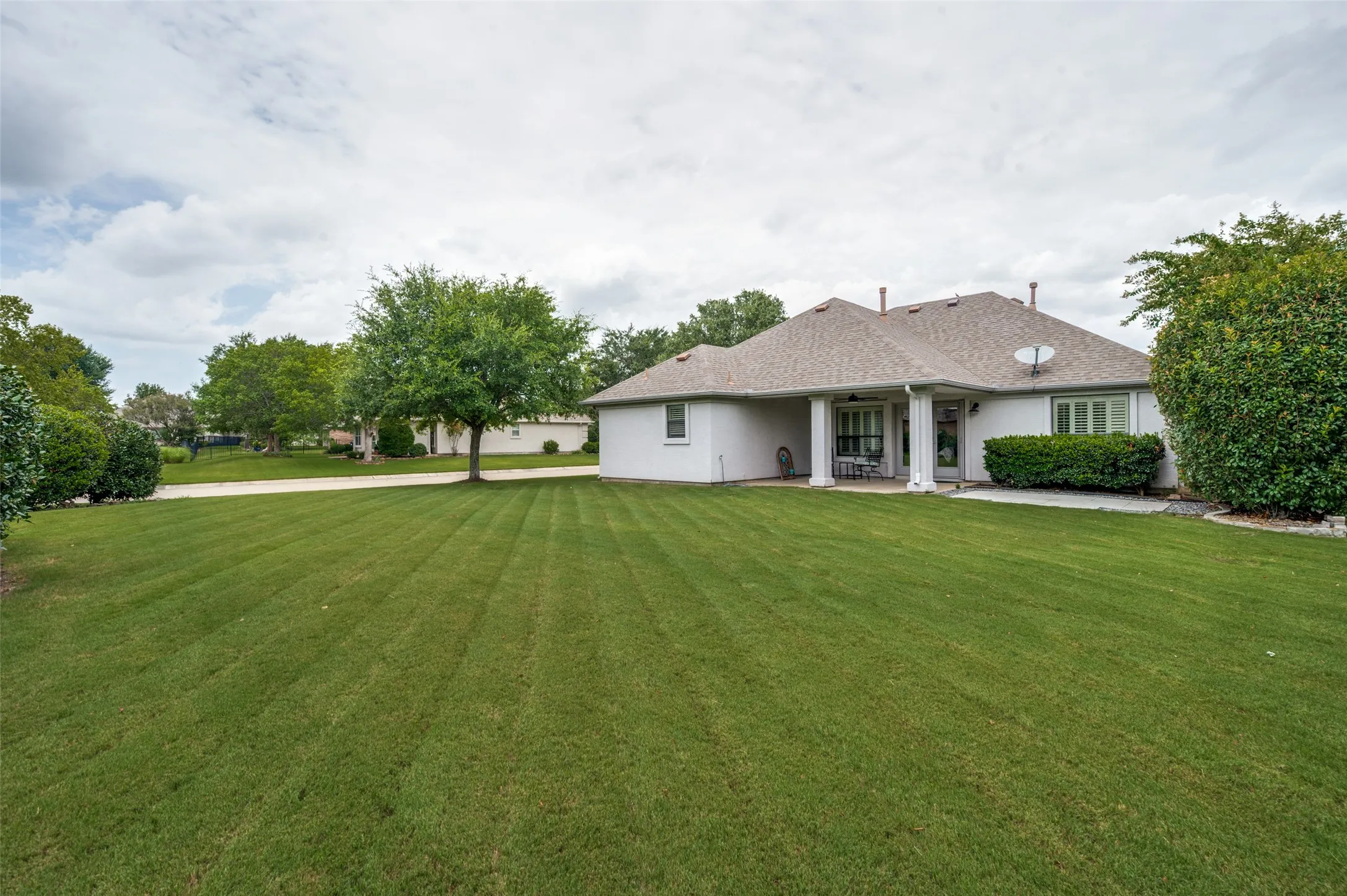 View from the rear corner of the property back toward the patio