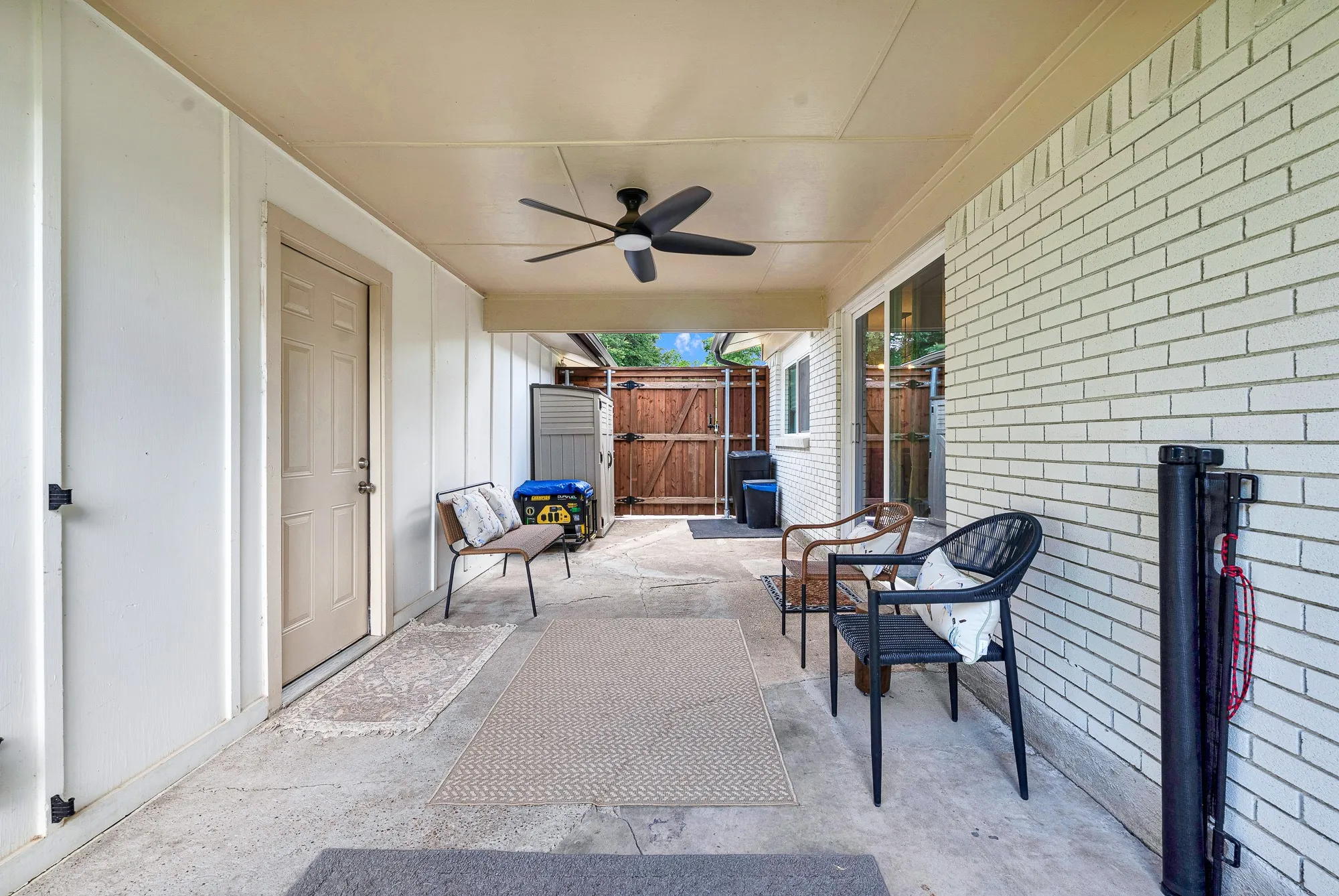Breezeway between house and garage, currently furnished as TV & entertainment area