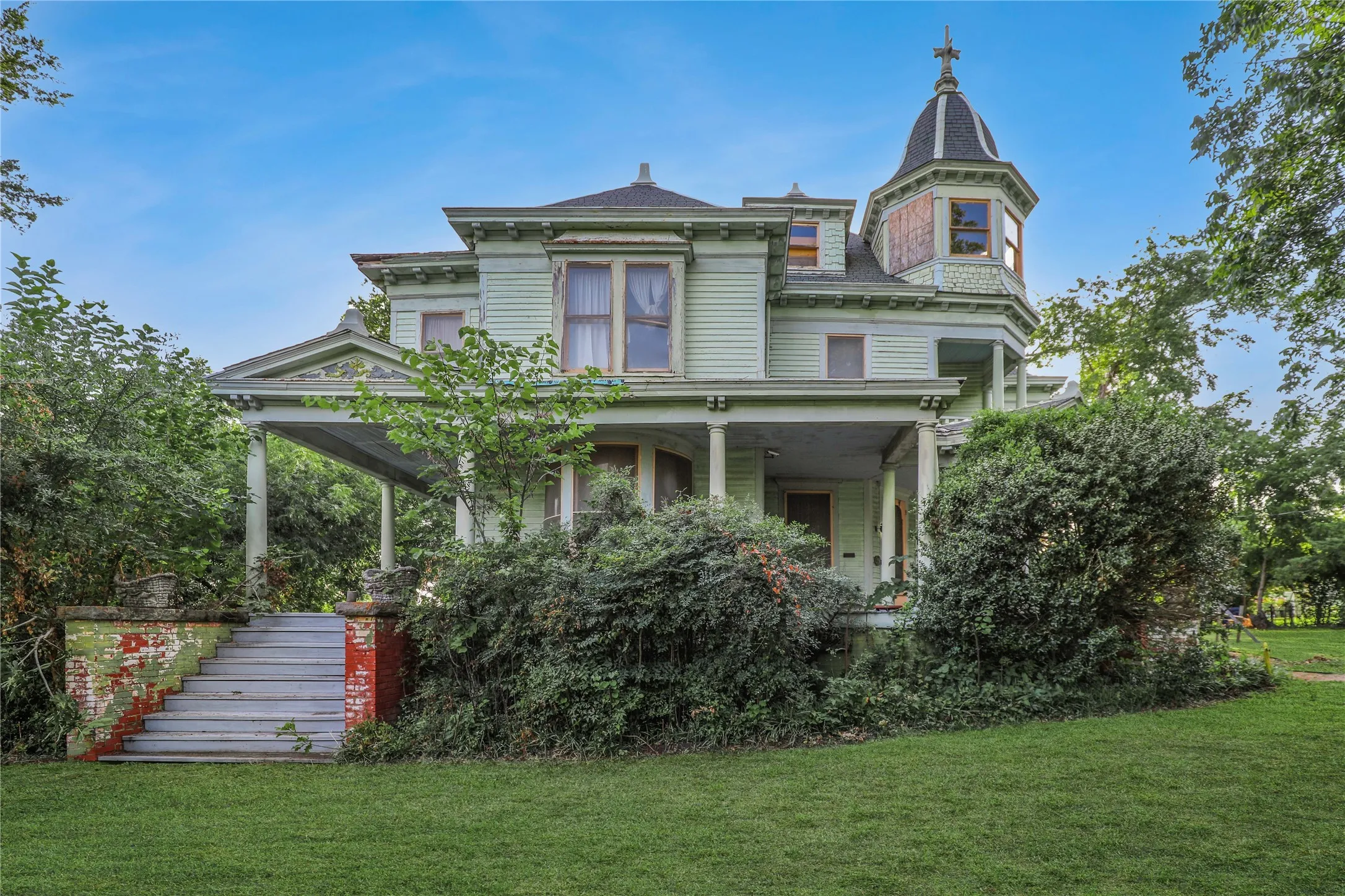 Victorian-style residence featuring a prominent turret and a full-width front porch with columns