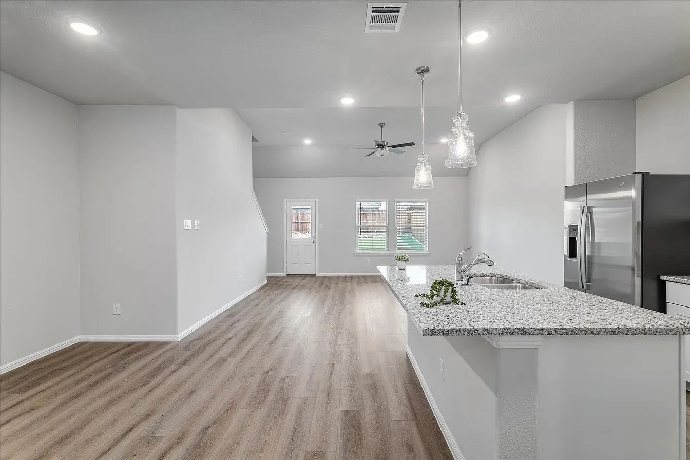 Open-concept living space featuring wood-finish flooring, recessed lighting, and a contemporary ceiling fan