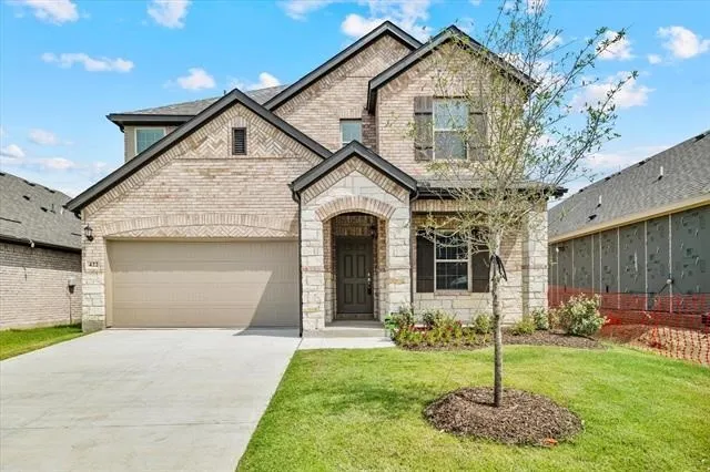 Two-story brick and stone facade with dark trim accents
