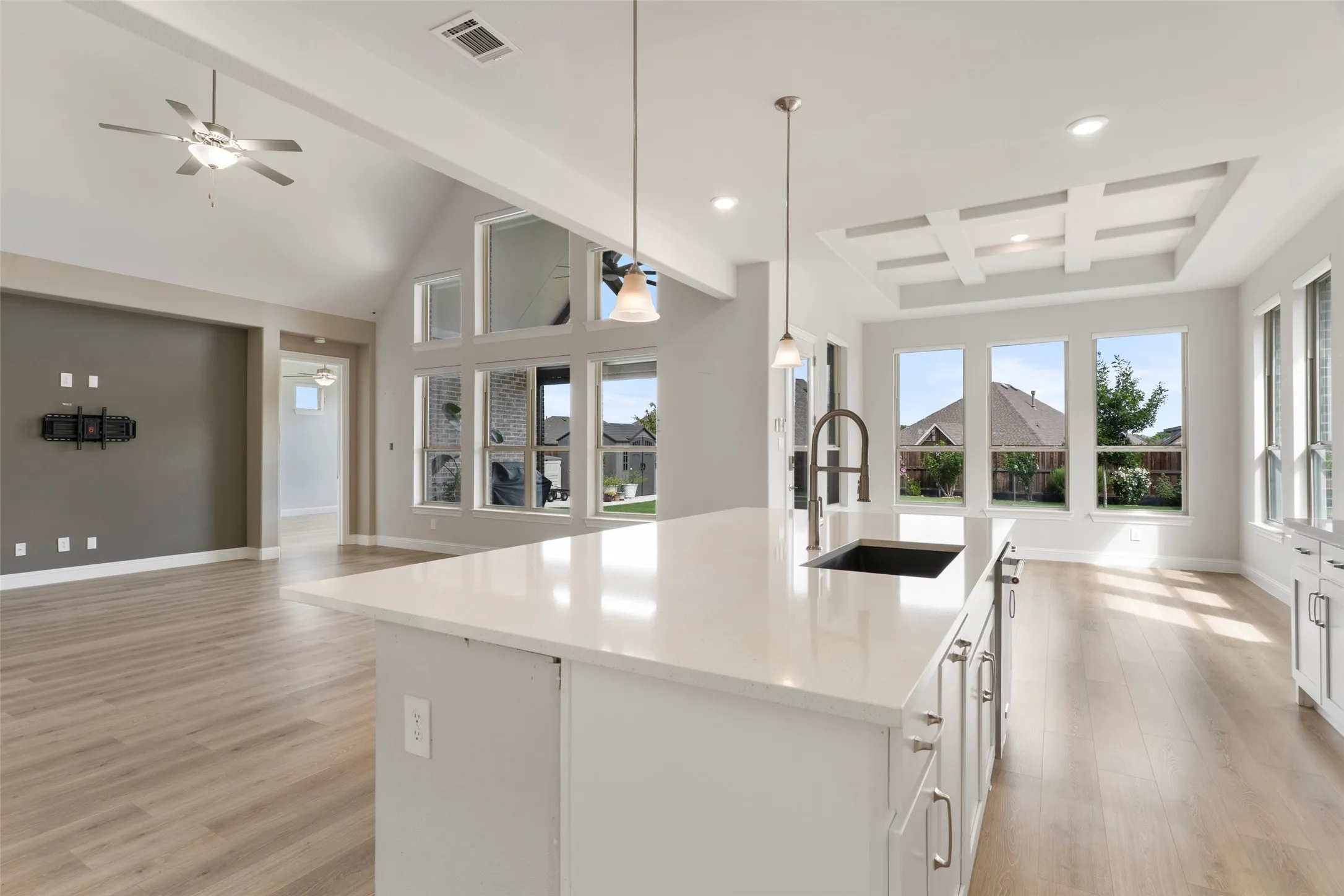 Kitchen island with quartz countertop, undermount sink, and gooseneck faucet