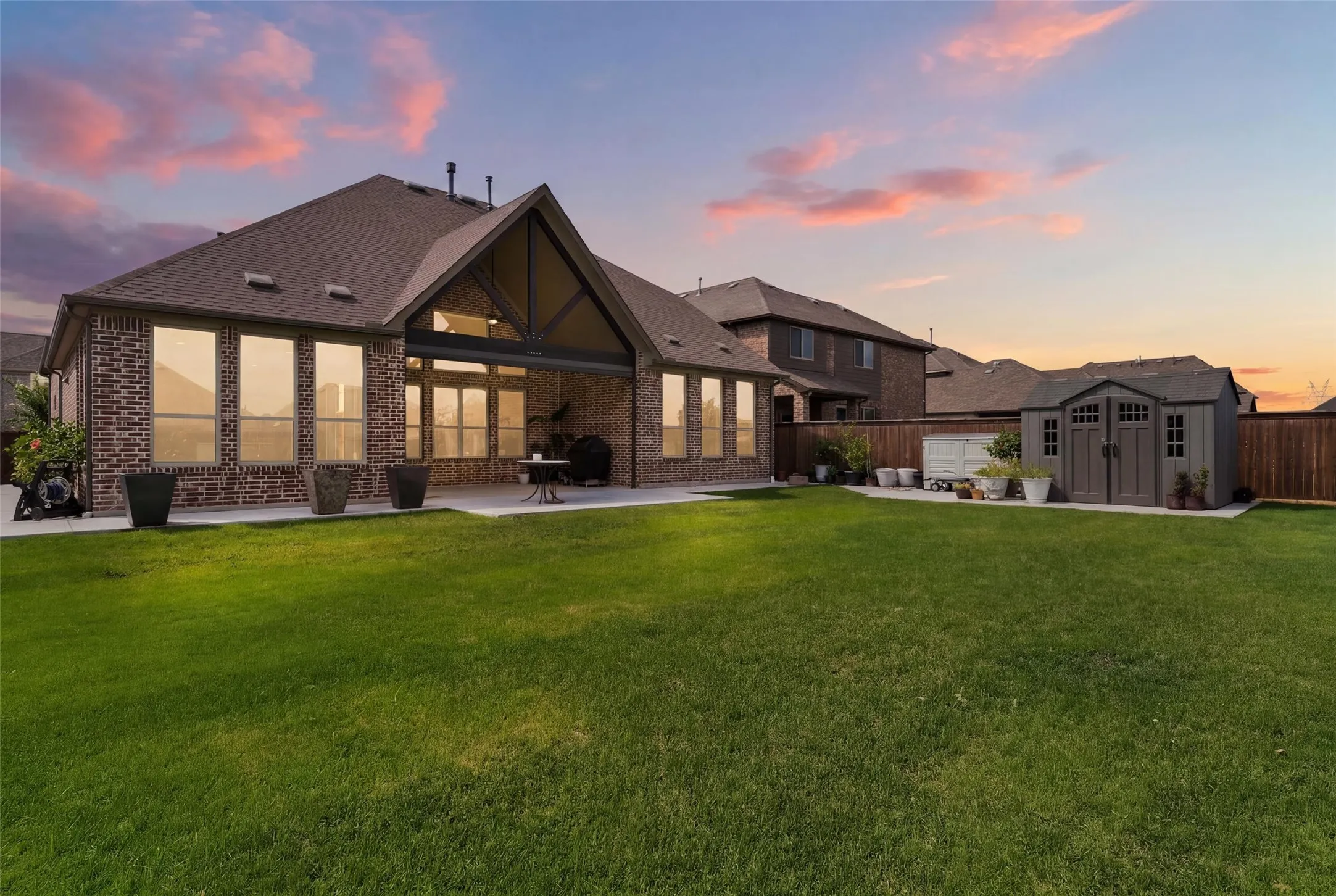 Expansive green lawn with a privacy fence